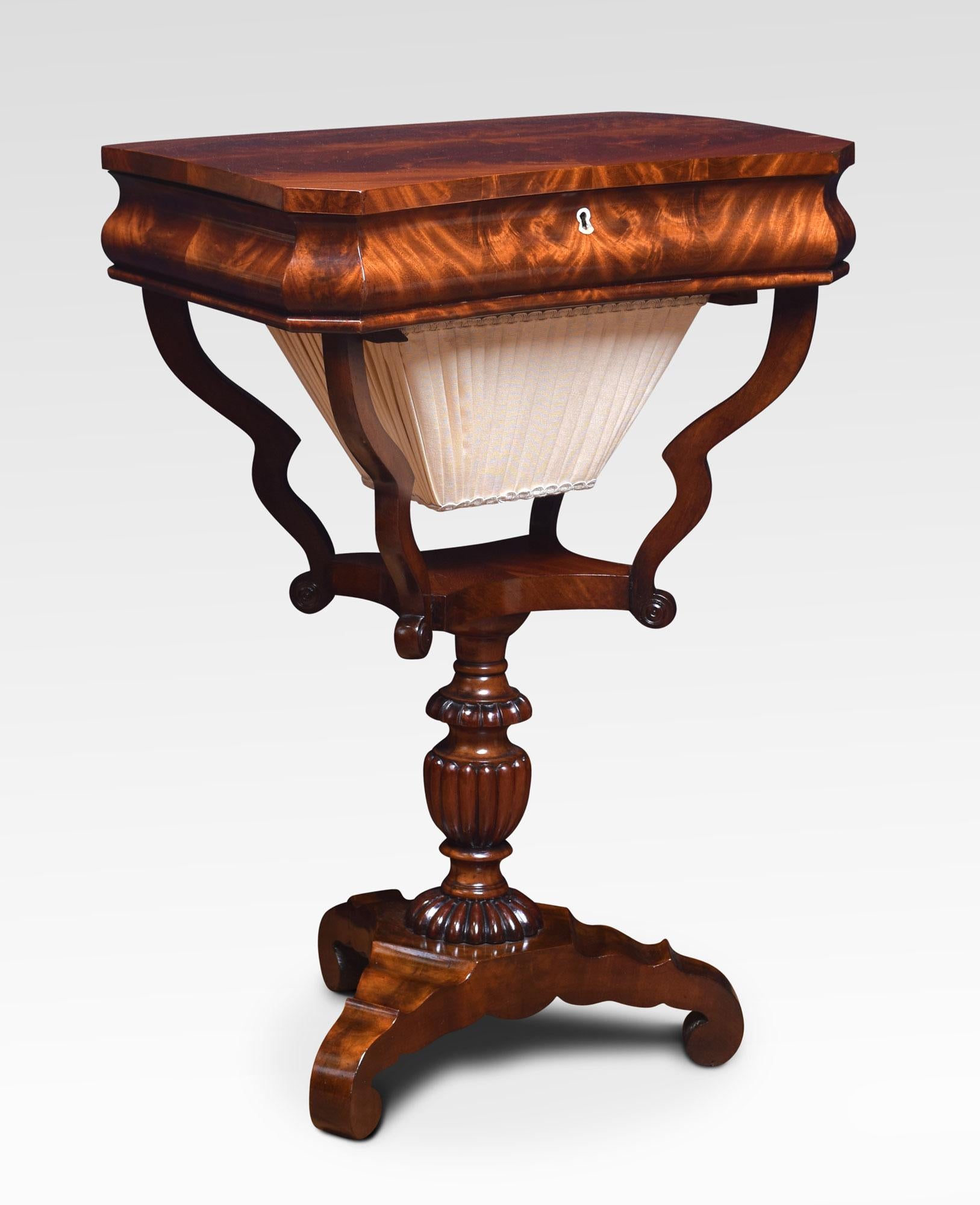 William IV mahogany work table, the inverted bow front top with hinged lifting lid opening to reveal lidded compartments above a shaped upholstered bag. Raised up on scrolling supports and turned lobed column. All raised up on tripod