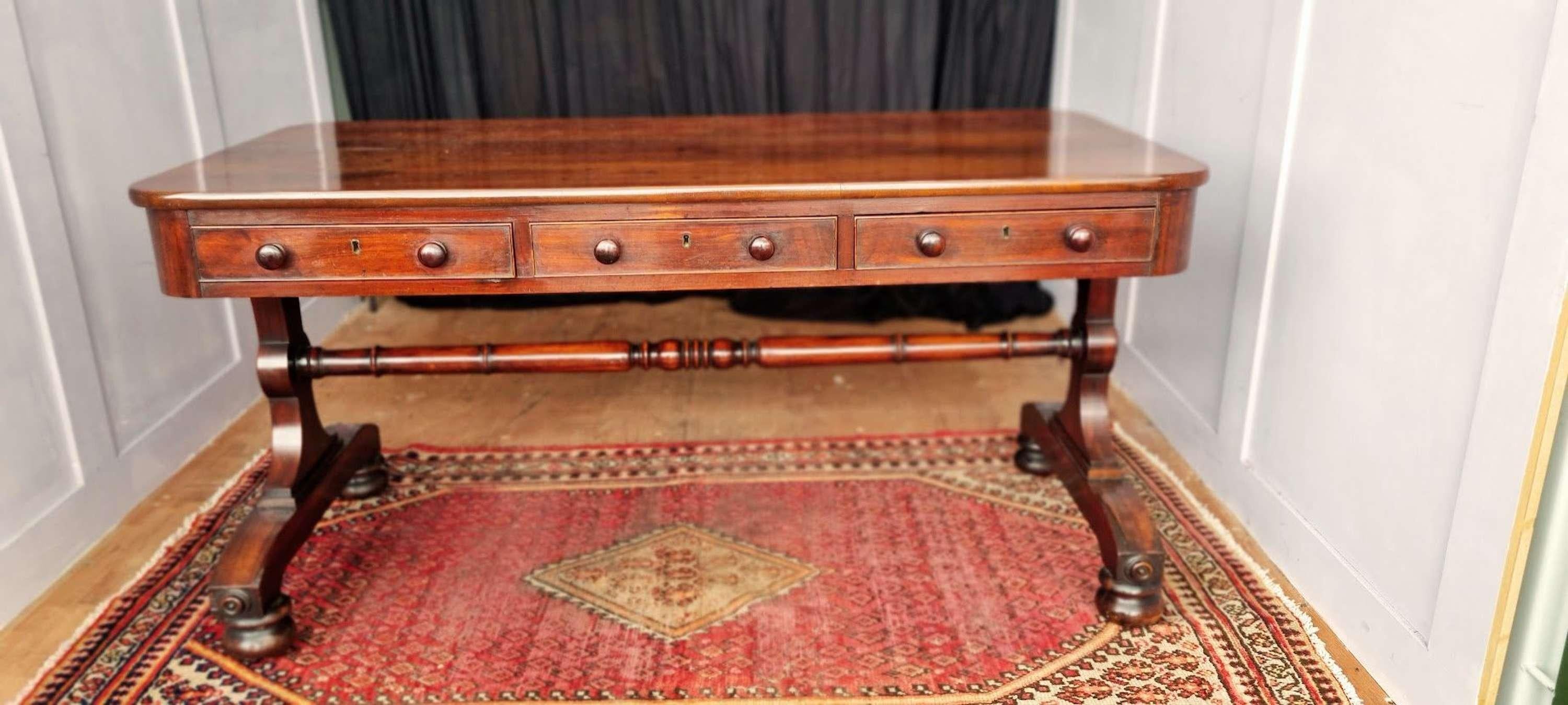 A very elegant Padouk wood William IV Library table 

With 3, all through, perfectly working, drawers and faux draw fronts to the rear.

Standing on sweeping side supports and turned stretcher with inset caster bun feet. 

Beautiful patina and
