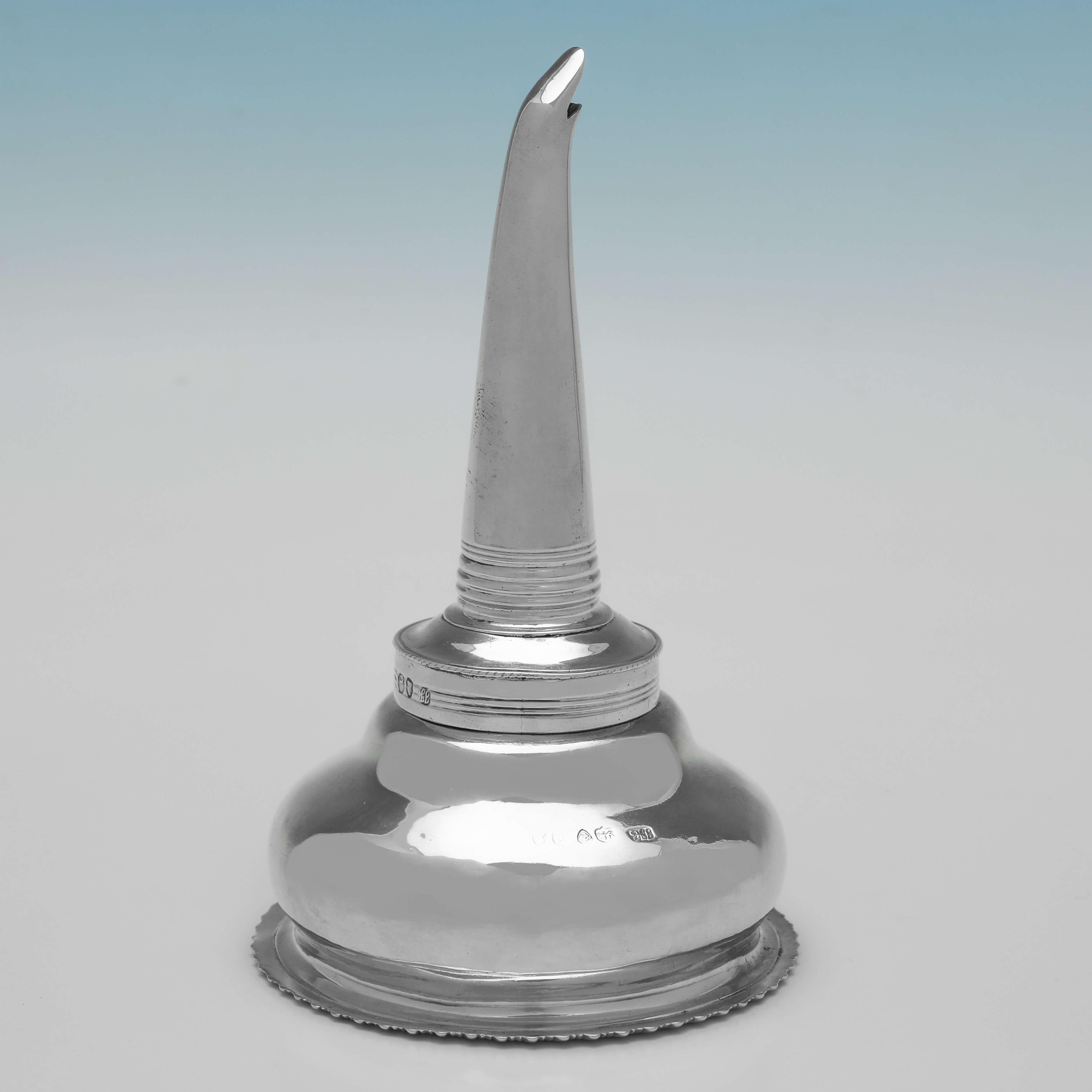 Hallmarked in London in 1832 by Jonathan Hayne, this handsome, William IV Period, Antique Sterling Silver Wine Funnel, is of traditional form, with a gadroon border, a shell thumb piece, and a removable muslin ring. 

The wine funnel measures