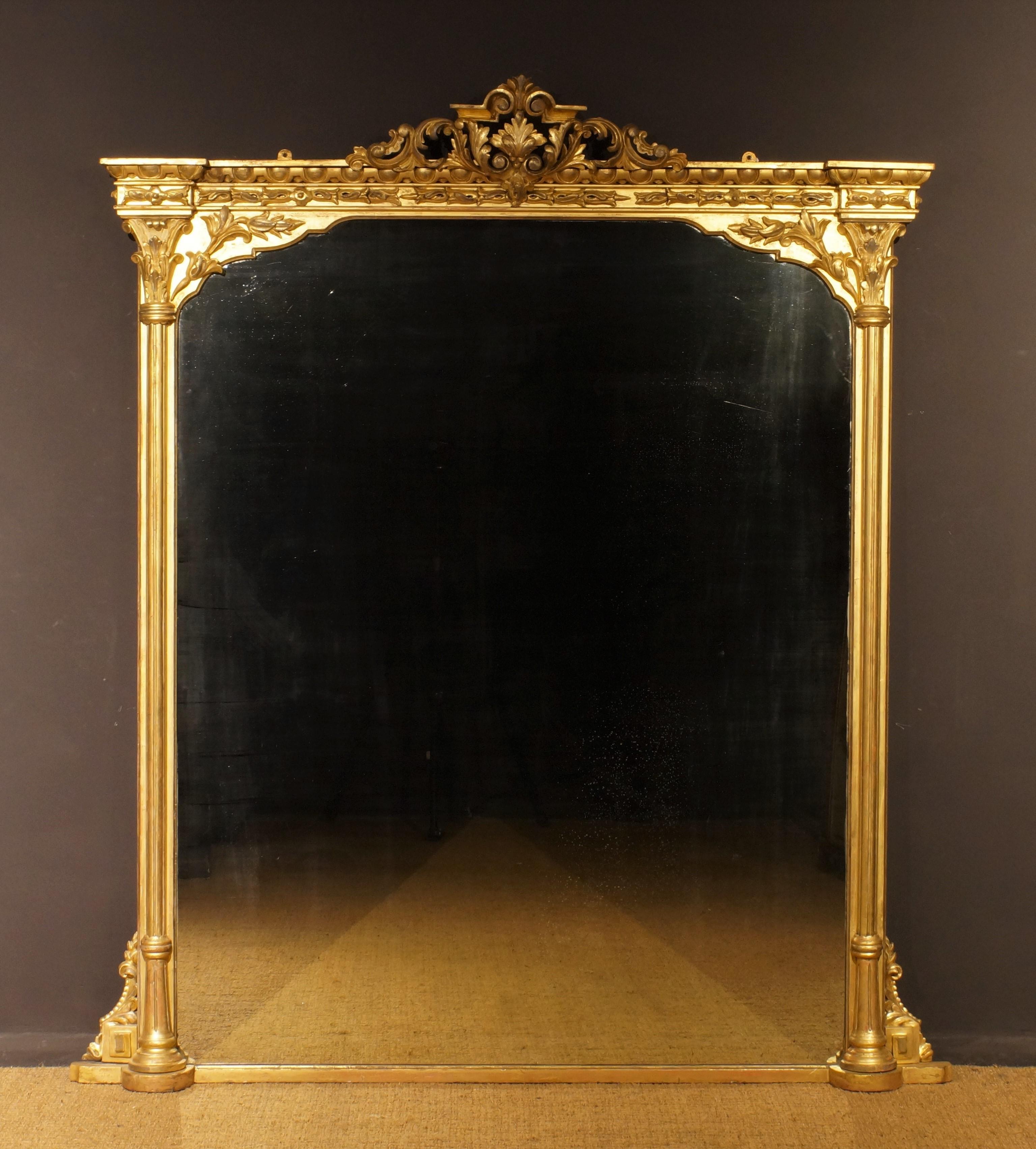 The top with egg and dart carving to the stepped cornice and tulip and rose carved decoration to the frieze, the side fluted pillars topped by acanthus leaf capitals; the bottom with foliate scrolls and stepped base.
Of rare grand scale this mirror
