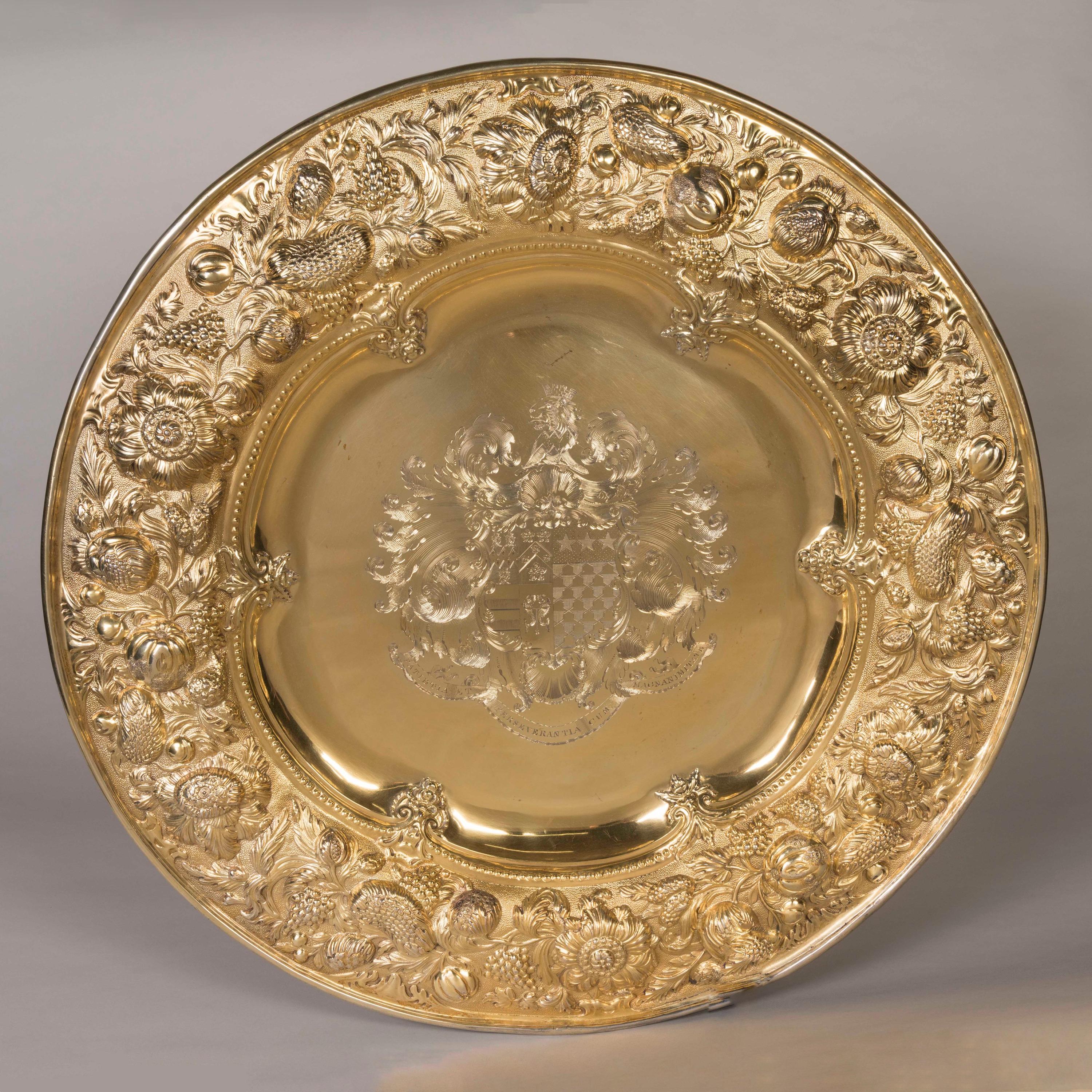 A Massive Silver Gilt Sideboard Dish
By Robert Garrard II

A splendid circular sideboard dish with a broad border, finely repoussé and chased in high relief with an intricate array of flowers, fruit, and foliage on a rich matted ground, all enclosed