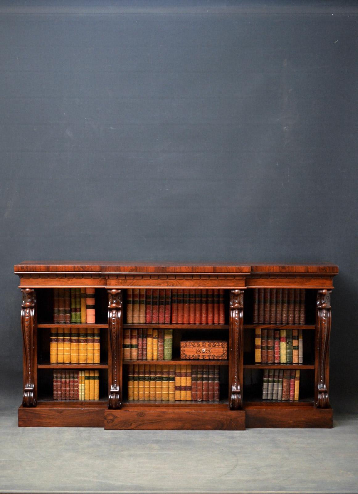 Sn4497 spectacular William IV low, open bookcase in rosewood, having stunning top above 3 open sections with height adjustable shelves all flanked by finely carved cabriole decoration, all standing on plinth base. This antique bookcase has been