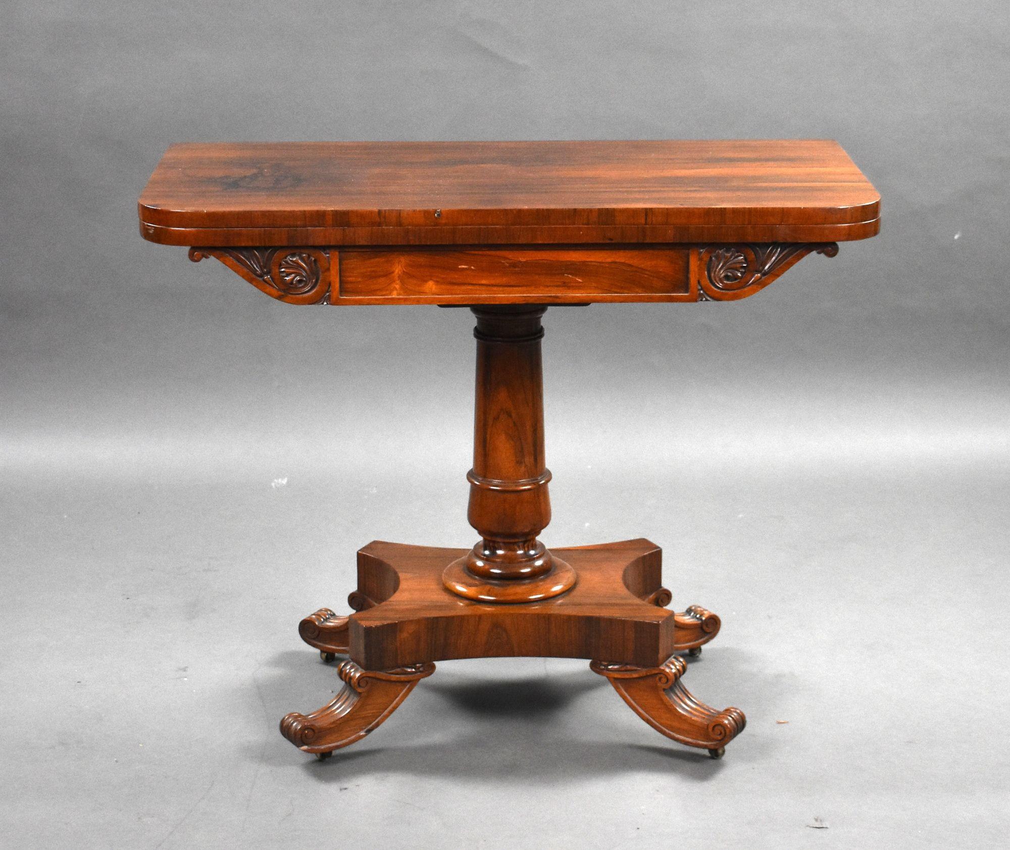 For sale is a good quality William IV rosewood card table, having a swiveling top that folds over, to reveal a green baise lined interior, above a cylindrical column over a platform base, raised on scroll feet terminating on original castors. This