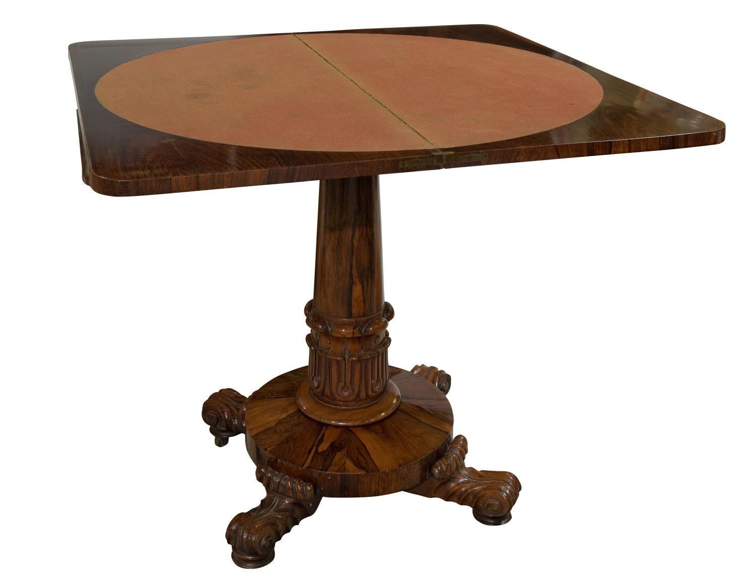 A William IV Rosewood card table standing on a central pedestal and carved base.

Circa 1830