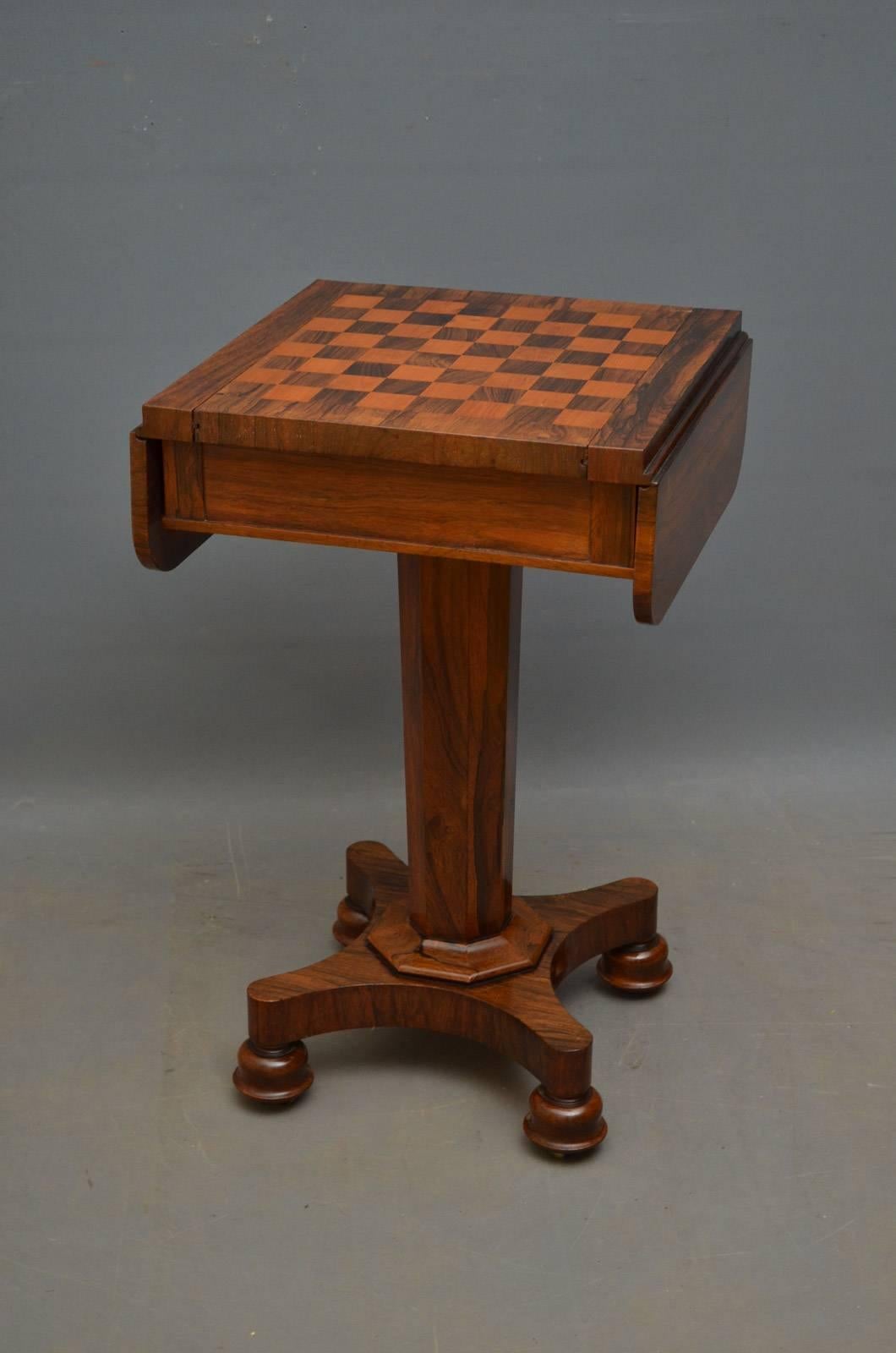Sn4262, unusual William IV chess table in rosewood, having drop leaf top with sliding chess board and flat faceted column terminating in quatrefoil base, turned feel and castors. This antique table retains its original finish which has been cleaned,