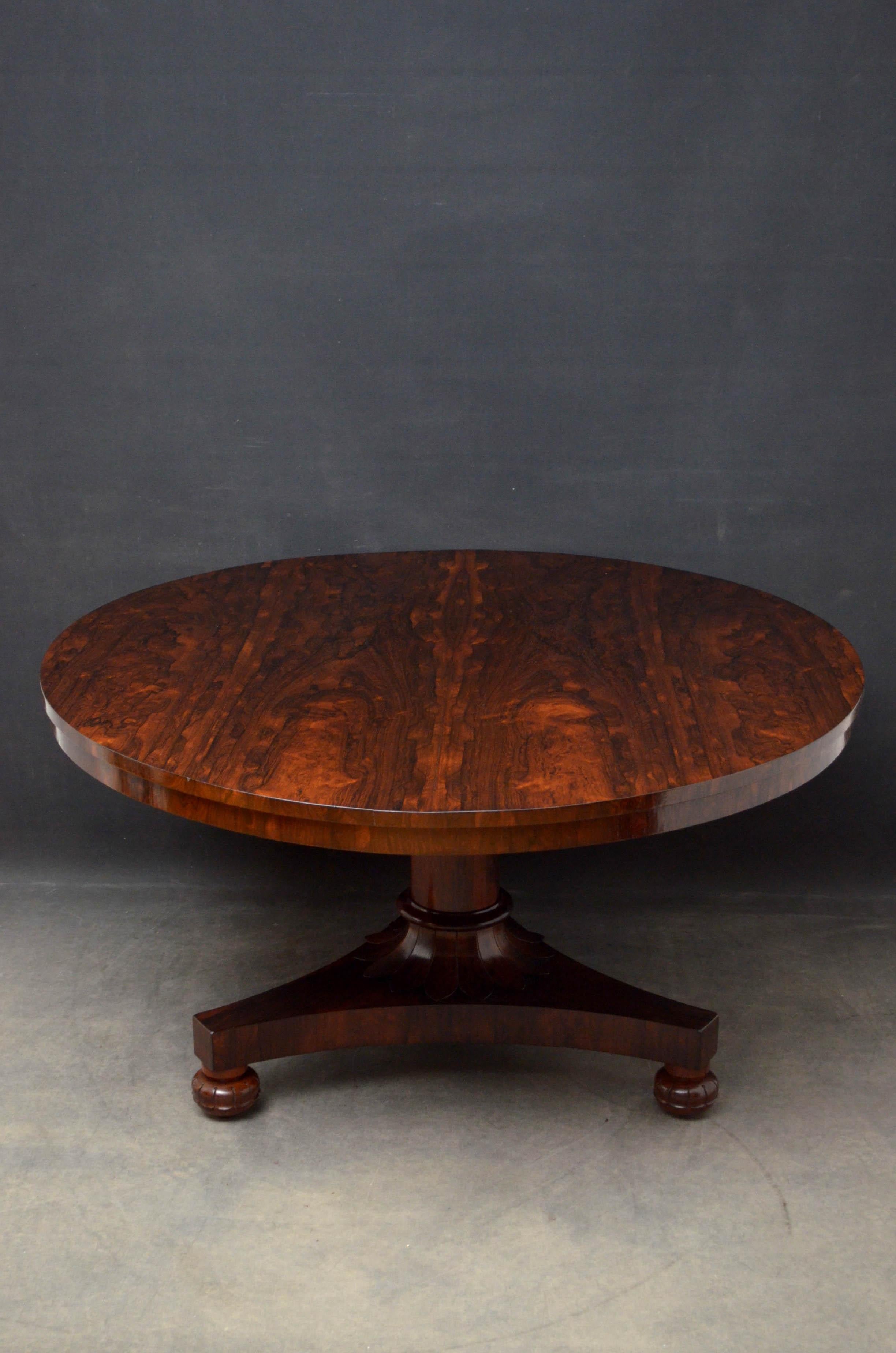 Sn4825 superb William IV rosewood, breakfast table having stunning grain to tilt top raised on tapered column terminating in petal carved collar, trefoil base and carved bun feet, standing on original brass castors. This antique dining table has