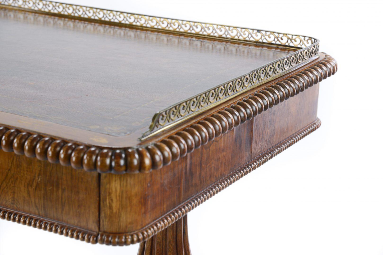 William IV rosewood library or writing table firmly attributed to Gillows, with leather top and brass gallery and fitted with two draws, the whole supported on two reeded and gadrooned columns with gadrooned bun feet.

Gillows of Lancaster and