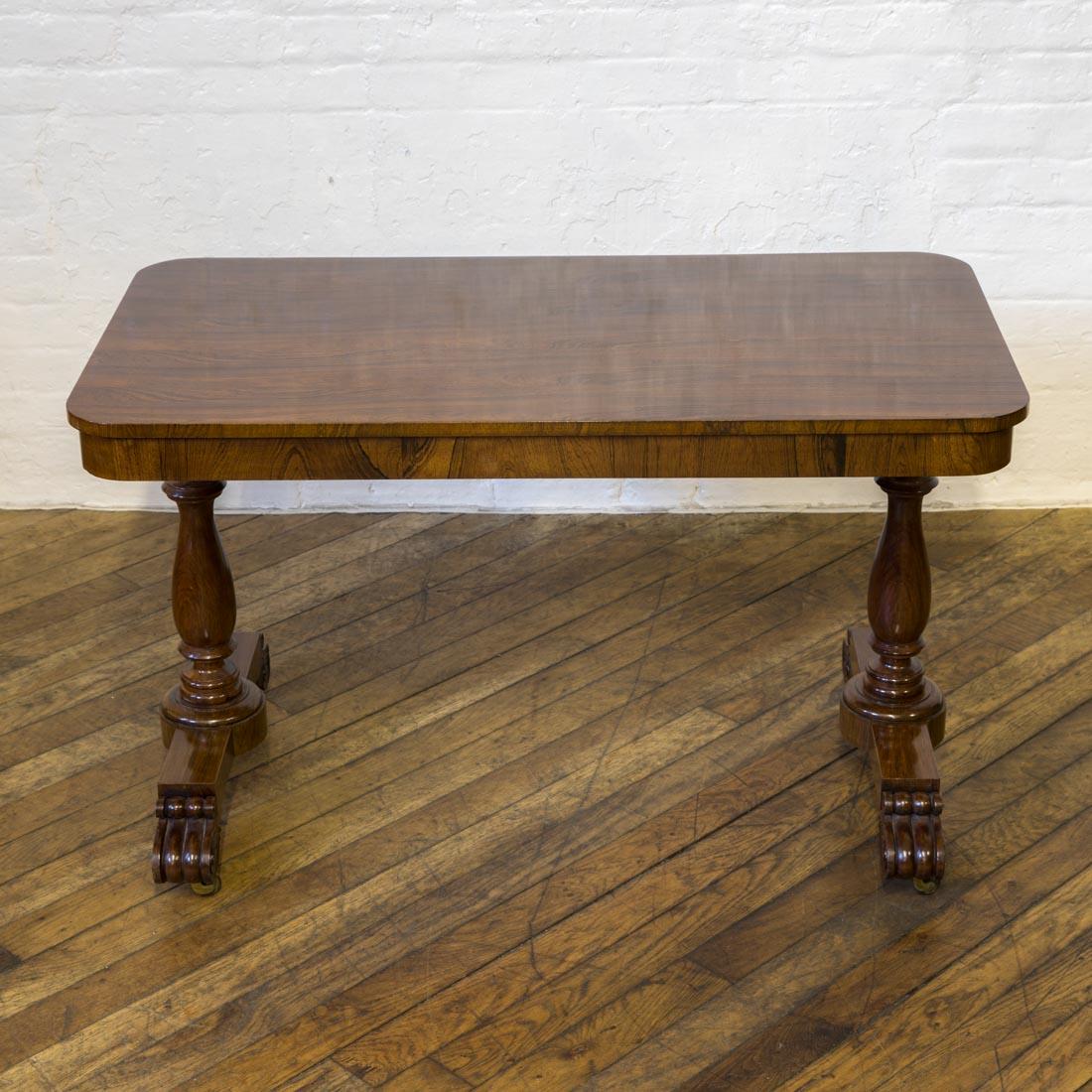 A lovely small rosewood library table from the William 4th period. With typical carved and scrolled feet and turned end supports and original working brass castors. The top was re-polished about 10 years ago and is still in excellent condition.
