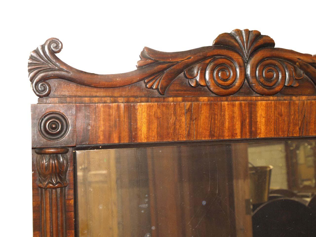 William IV rosewood mirror, with nicely carved and shaped cornice, the original mirror glass surrounded by rosewood veneer, the sides with fluted pilasters have carved capitals and bases, the bottom of the mirror steps out.