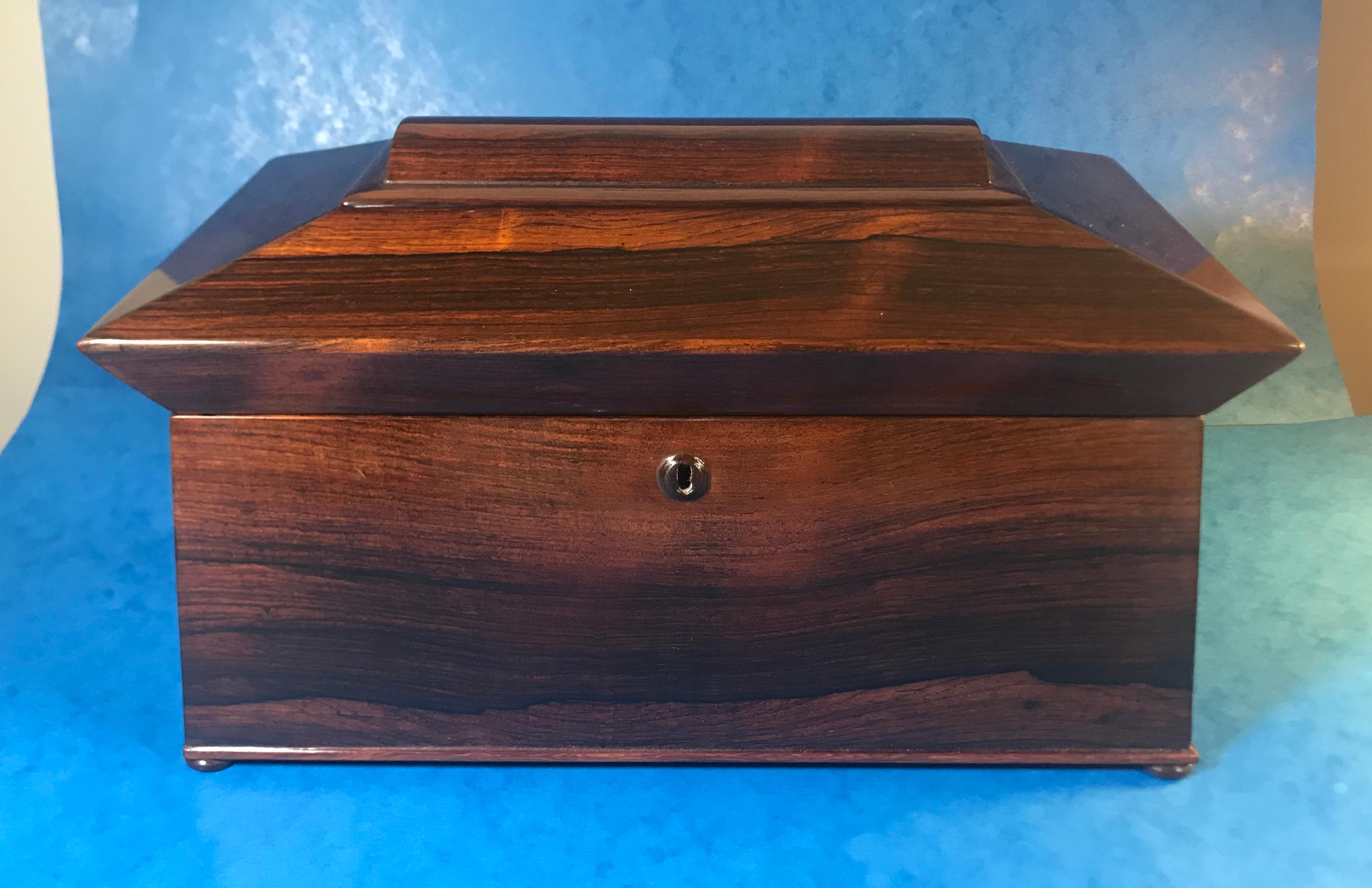 William IV rosewood sarcophagus tea caddy.
A wonderfully simple but Classic twin canister tea caddy in superb condition.
The tea caddy sits on four rosewood bun feet with ring handles to the sides. It dates back to circa 1830.
The box has a fully