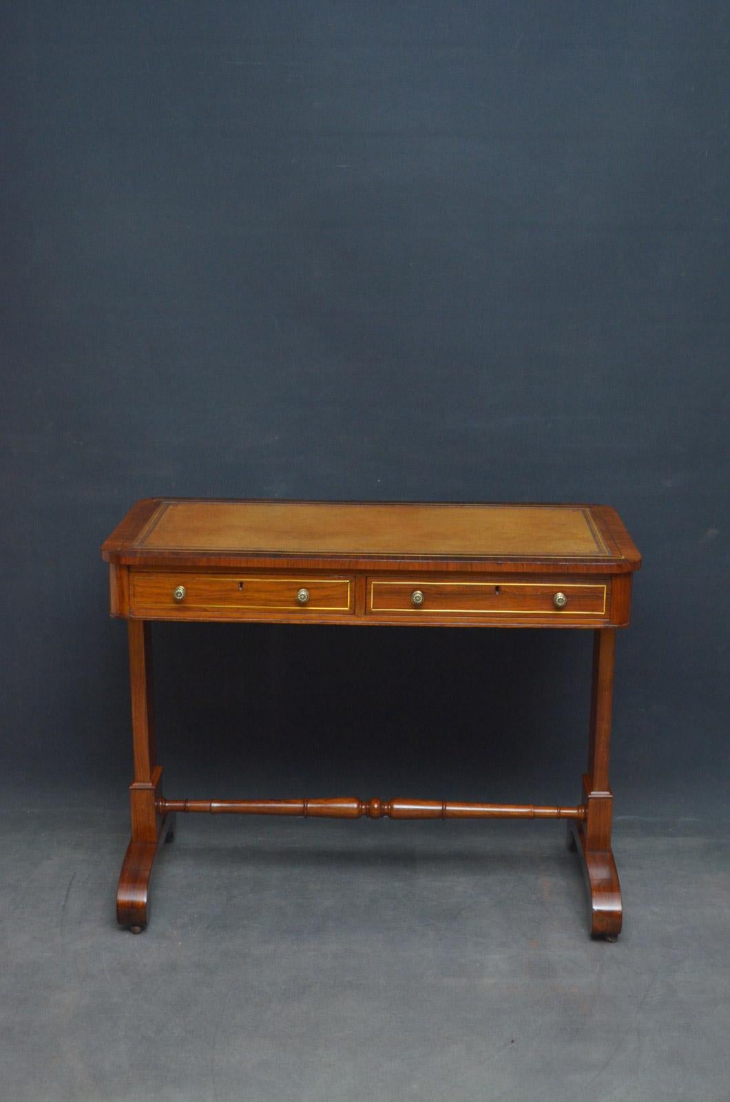 Sn4567 Elegant William IV writing table / library table in rosewood, having brass inlaid top with tan leather writing surface and 2 brass inlaid frieze drawers fitted with brass handles, all standing on simple supports terminating in downswept legs