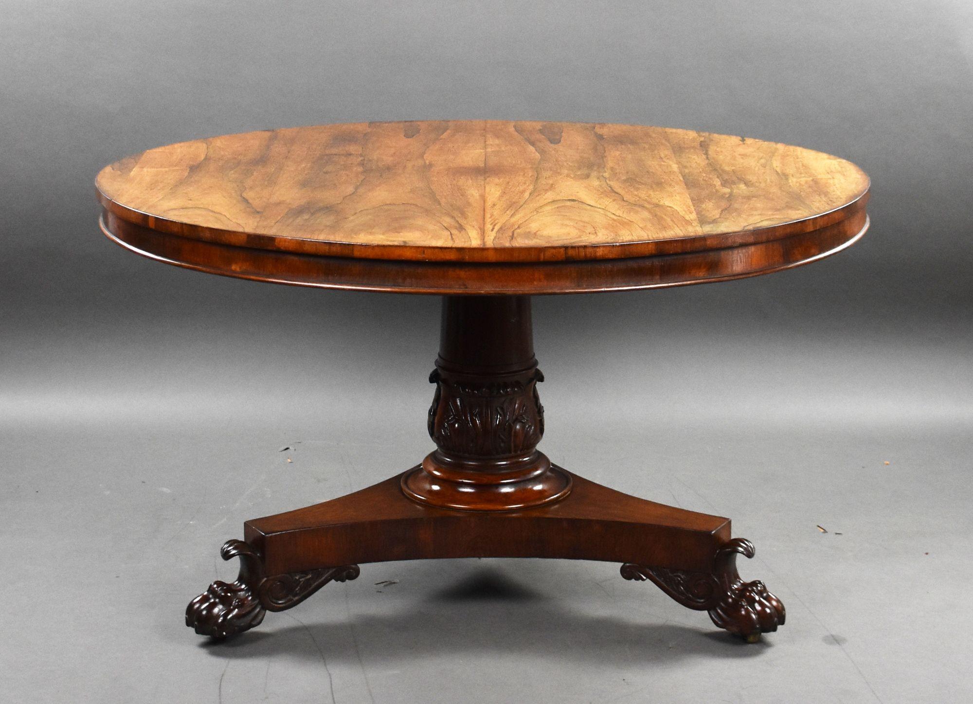 For sale is a good quality William IV round rosewood breakfast table, the faded and well figured top, above a cylindrical column with a carved base, standing on elegant paw feet, raised on castors. The table remains in very good condition for its