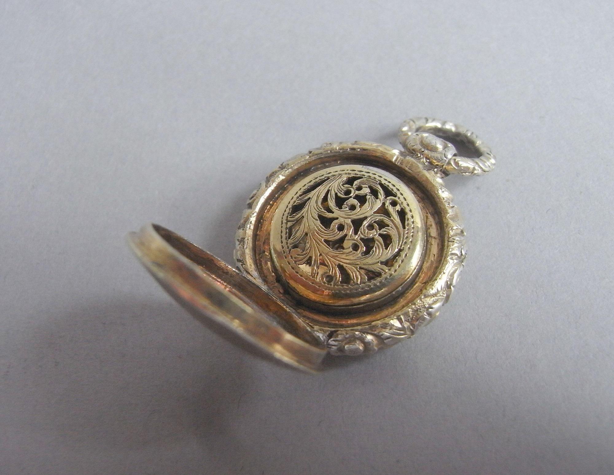 A William IV silver gilt Vinaigrette of unusually small size, probably for a child. Made in Birmingham in 1831 by Thomas Shaw.

The Vinaigrette is silver gilt and is modelled as a pocket watch. The small size leads us to believe that it may well