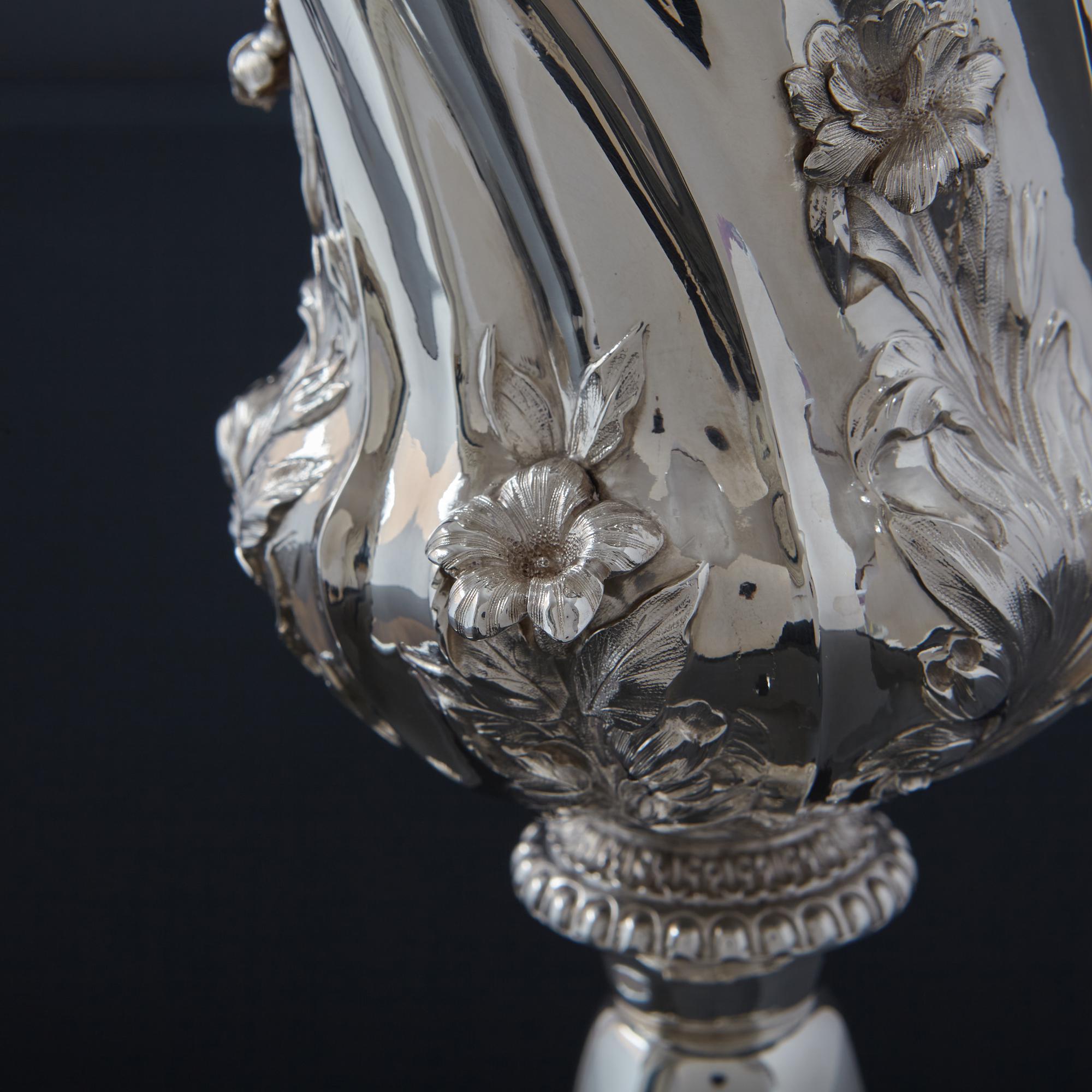 A large and beautifully made antique silver goblet with highly defined hand-chased floral and foliage decorations around the body and base. With a gilded interior, the goblet bowl also incorporates chased and swirled fluting and applied cast flower