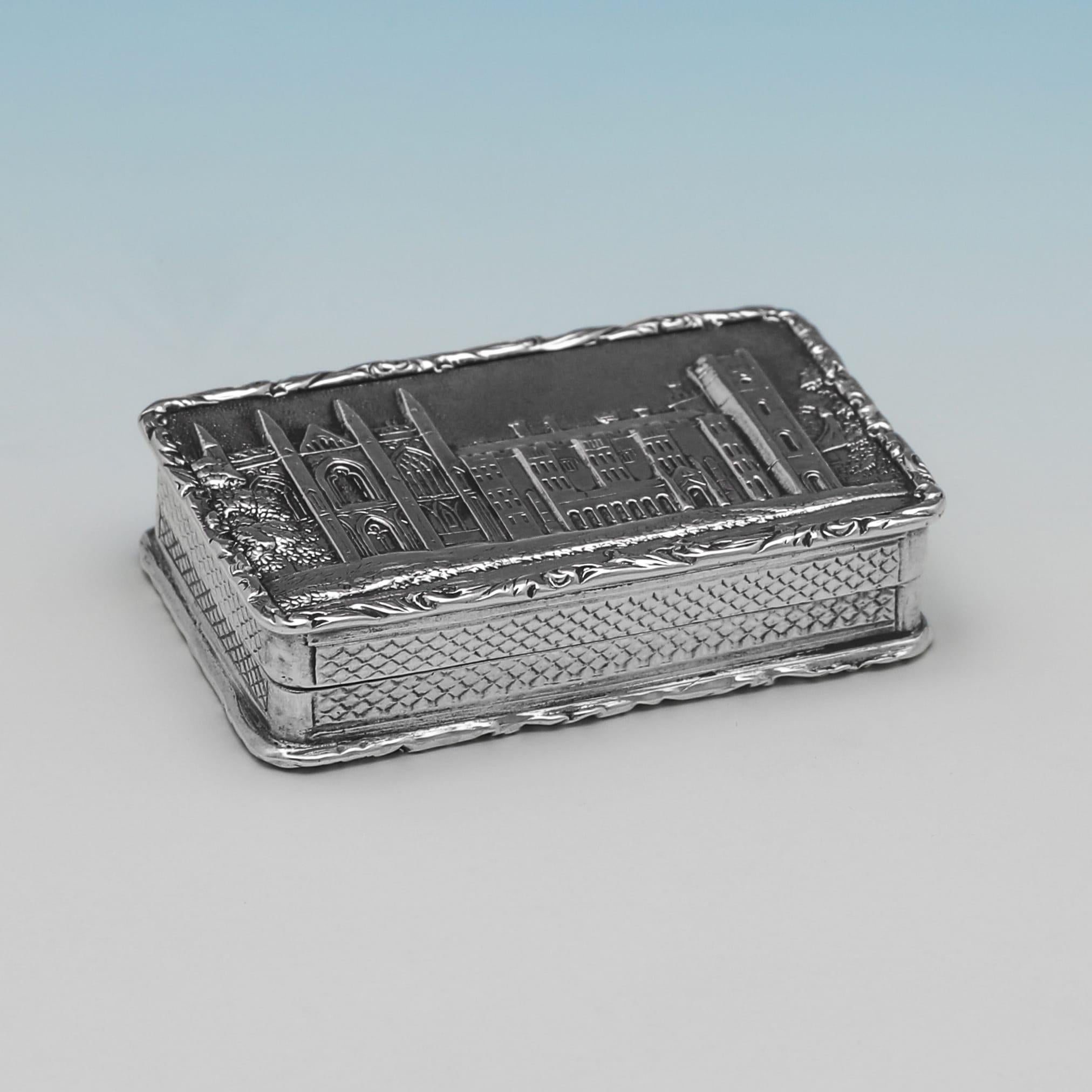 Hallmarked in Birmingham in 1835 by Taylor 
Perry this remarkable William IV sterling silver vinaigrette is of a rectangular form with a hinged lid. The 'castle top' lid is decorated with a high-relief repoussé and chased scene of Newstead