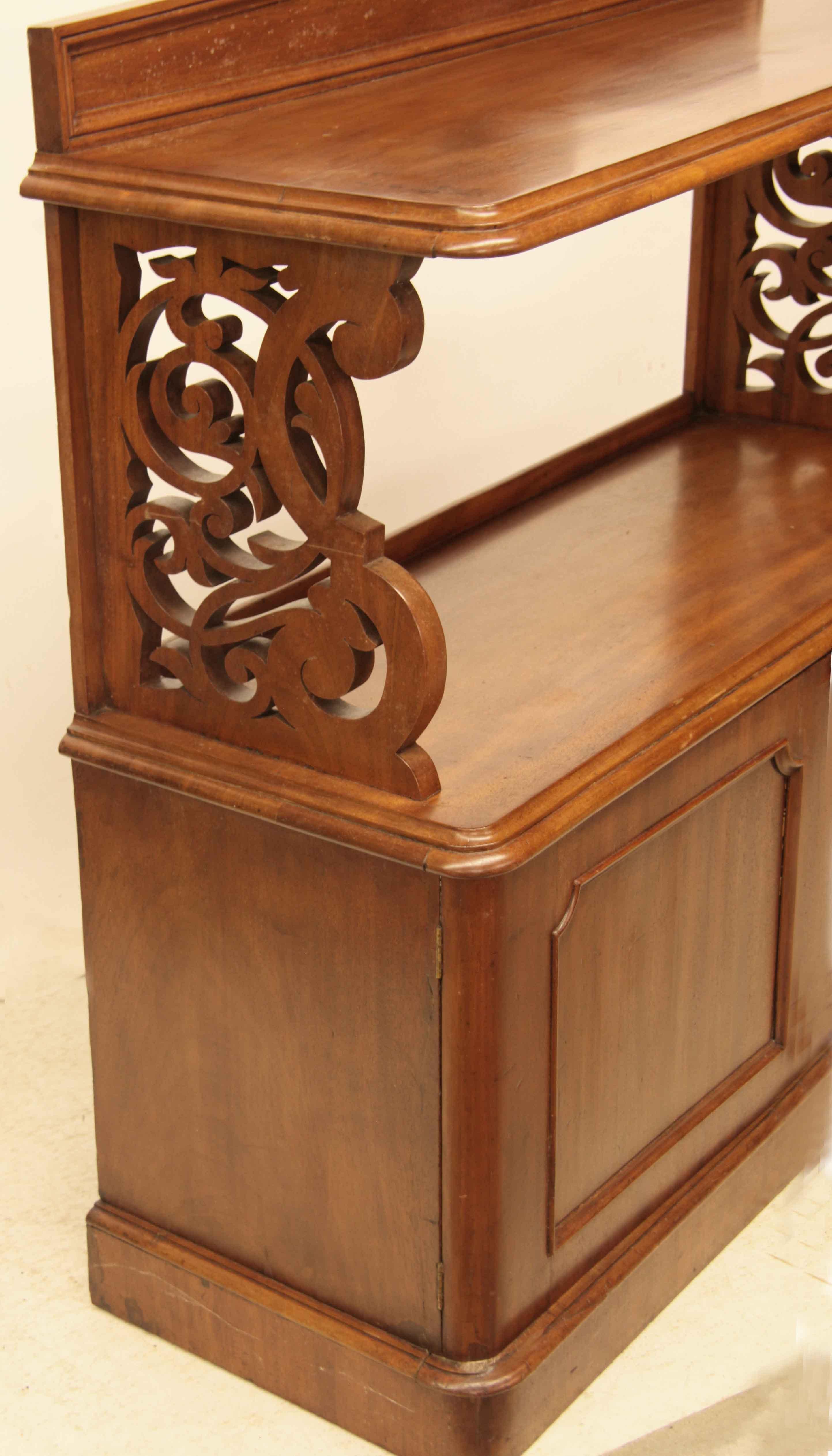 William IV two tier buffet, with gallery back surrounded by cove molding; top and lower shelf with beautiful faded mahogany color , molded edges.  The outstanding features are the two reticulated side supports with a multitude of curves and curls.  