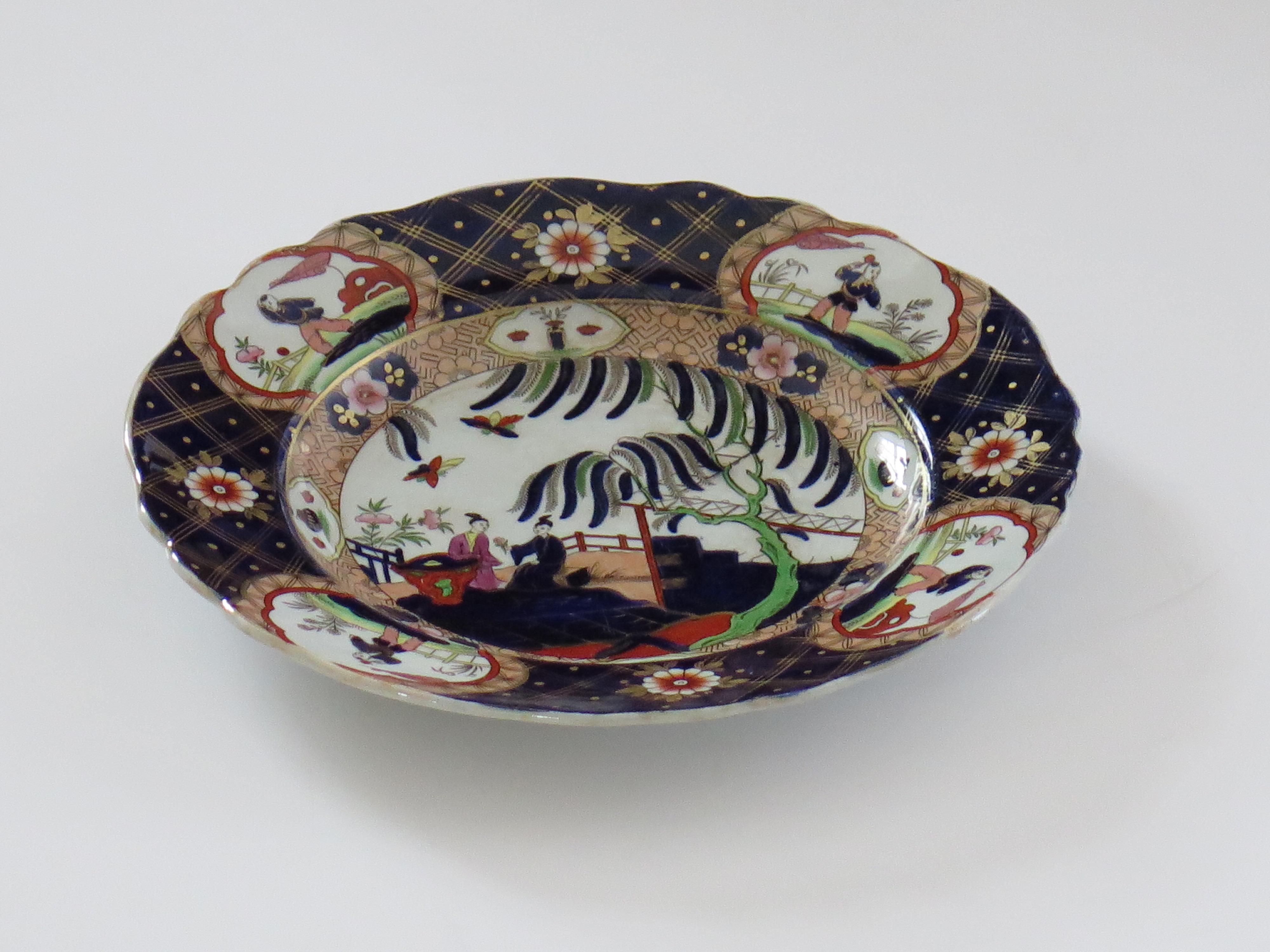 This is a highly decorative, Imperial Stone China (ironstone), plate by John Ridgway, dating to the William IVth period of the 19th century.

The plate is well potted with a wavy rim.

The plate has been carefully hand-painted in bold colorful