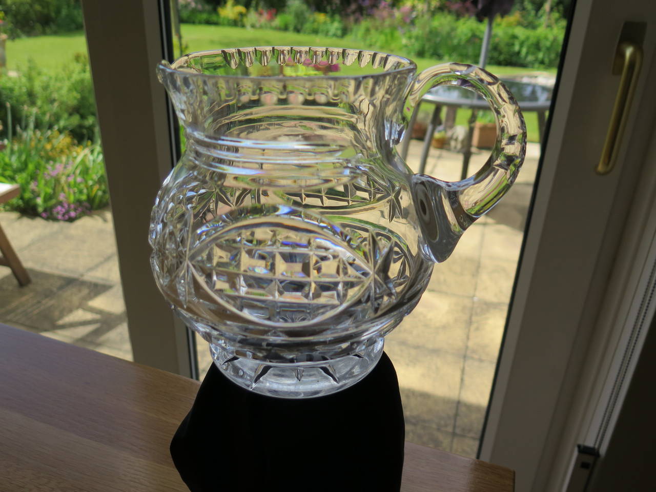 This is a high quality lead glass, hand blown, water jug or pitcher which we date to the William IV period, circa 1835

This jug is heavy (about 1.3 kg) and holds over 2 pints.

The jug is globular in shape with a footed base. The shape has been