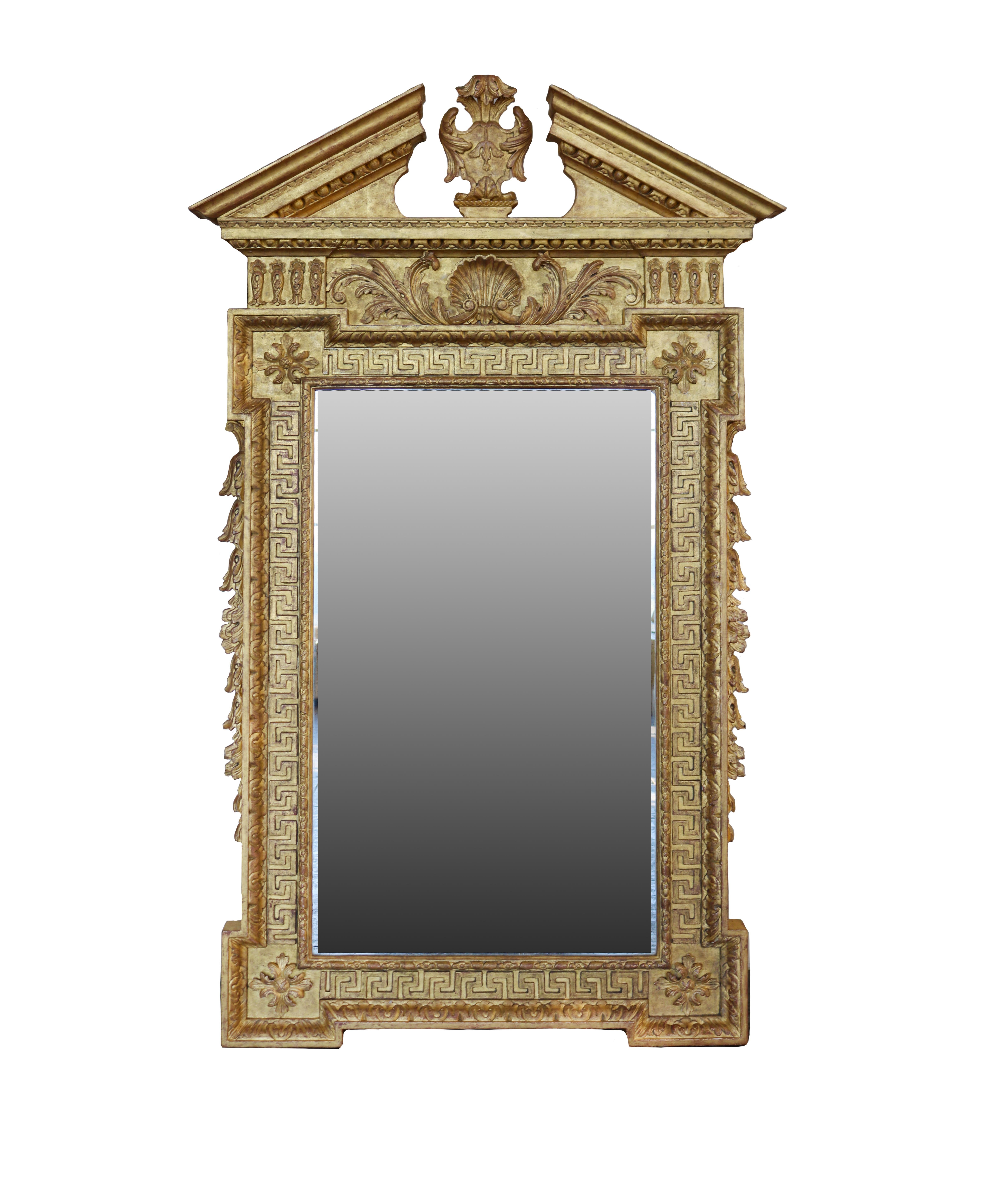 A pair of large wall mirrors after William Kent, in well carved gold leaf frames in a classical antique style with aged distressed plates.