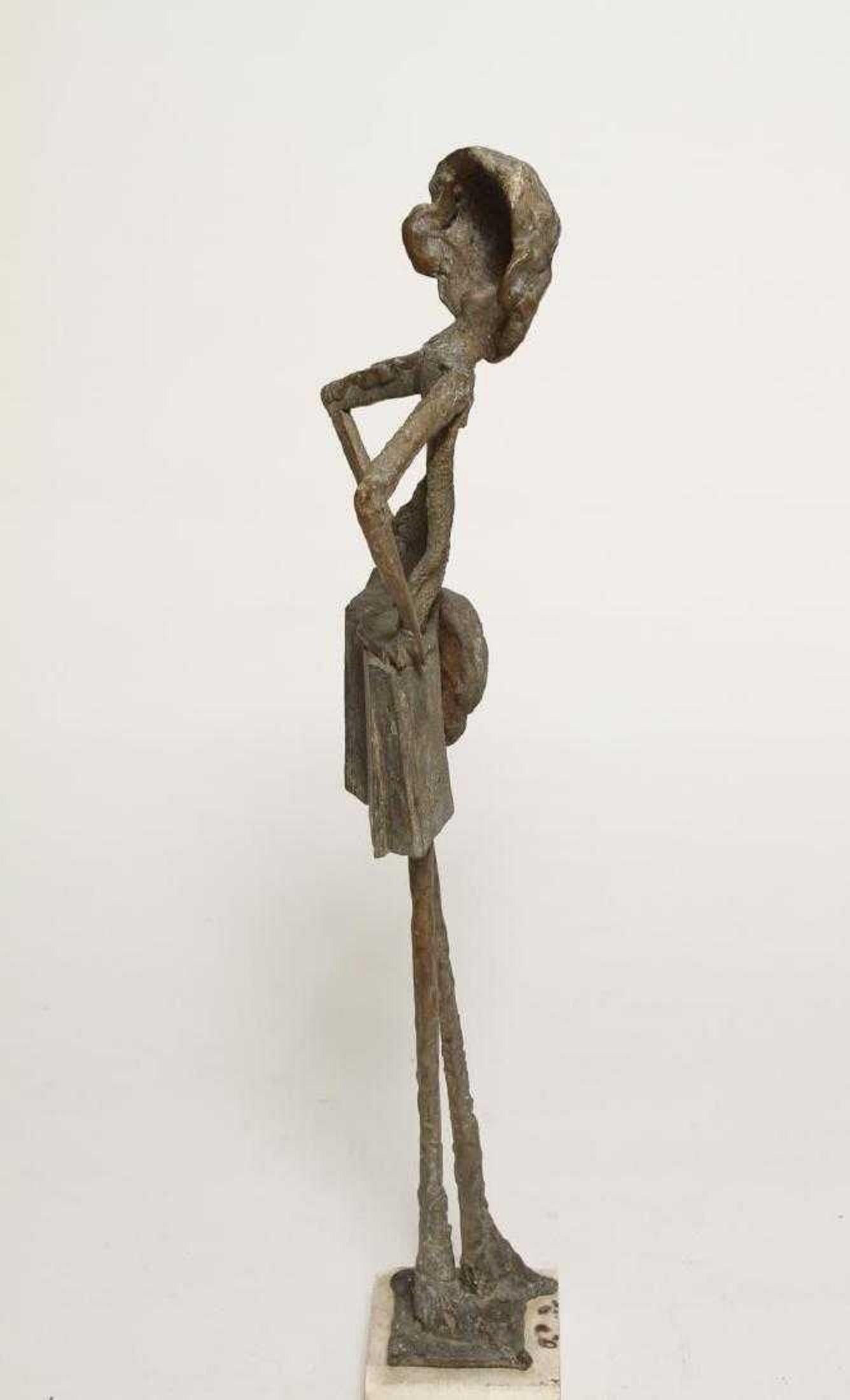 Mid-Century Modern wrought iron sculpture a person with oversize top, shorts, and carrying a hat, signed, artist's monogram and cipher, further mounted on a plaster base. 28