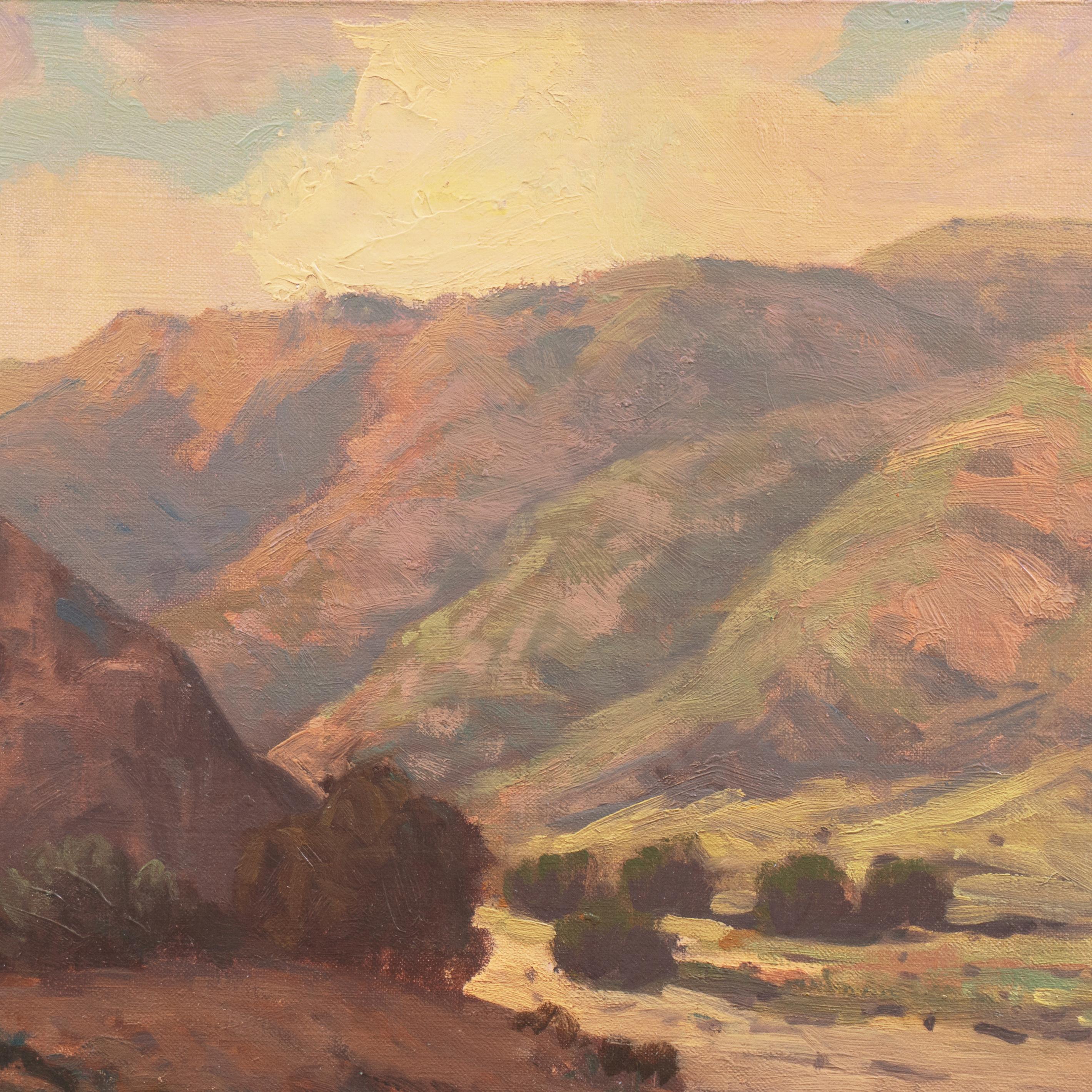 Signed lower right, 'Wm. P. Krehm' for William Krehm (American, 1901-1968) and painted circa 1940.

A period oil painting showing a mountainous, desert landscape at dusk, most likely a view of a Santa Ana River tributary in Southern California's