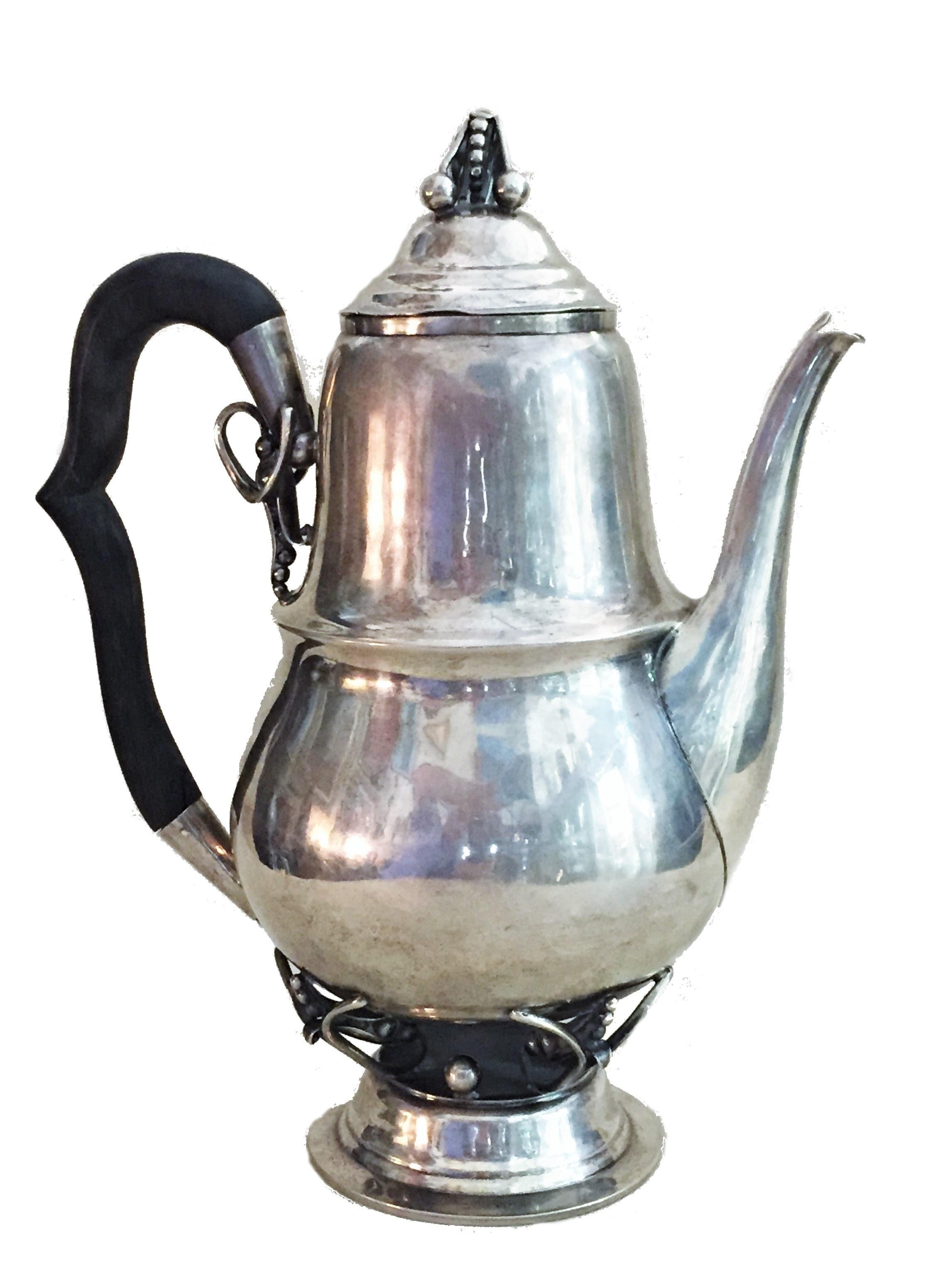 Dimensions & weight:
Height: 10.75 inches
Width: 3-1/2 inches
Depth: 5.25 inches
Weight: 27.4 troy oz

This wonderful sterling silver & wood coffee & tea kettle, made by the famous New York master-silversmith William Lawrence deMatteo, very