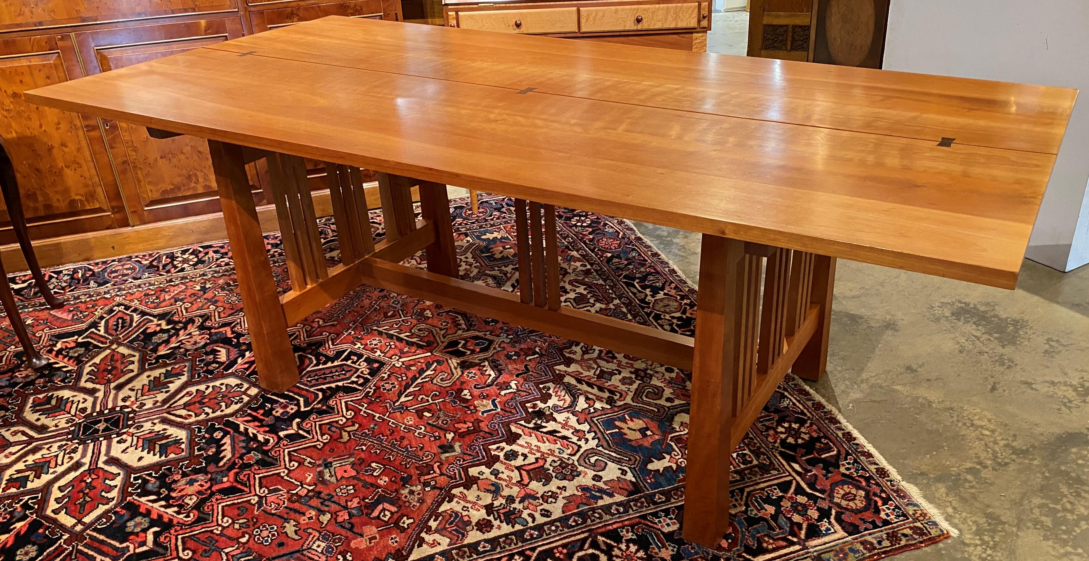 An exceptional quality cherry Vermont bench made Arts & Crafts style dining table with six chairs, including two arm chairs and four side chairs, butterfly jointed top, tapered legs, and attractive foliate upholstered seats. Each chair is hand