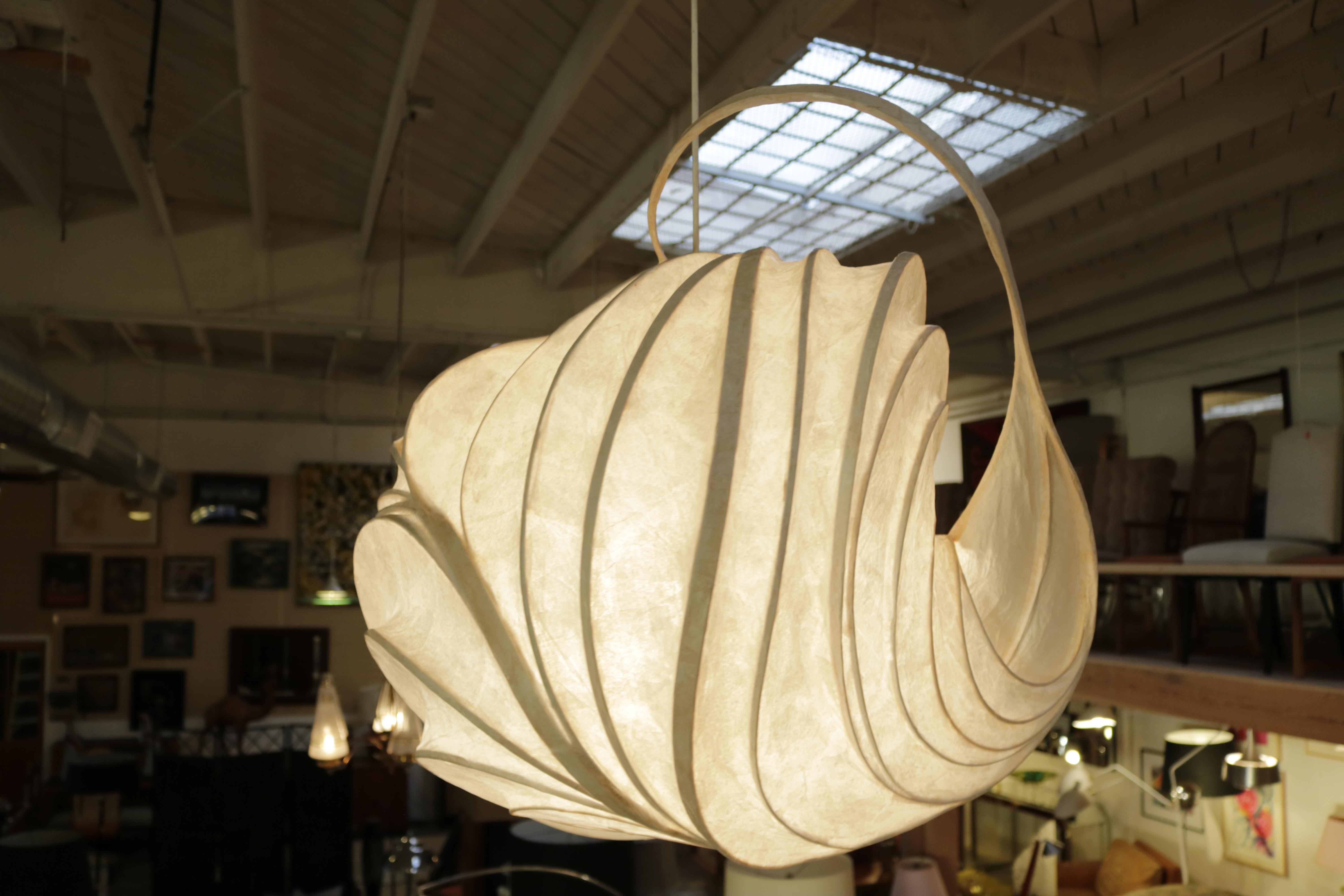 An original William Leslie 'light sculpture' in onion-like bulbous shape made from thin strips of wood bent into a frame then covered with paper soaked in polyvinyl resin and internally by incandescent light bulbs.
Following the light around it