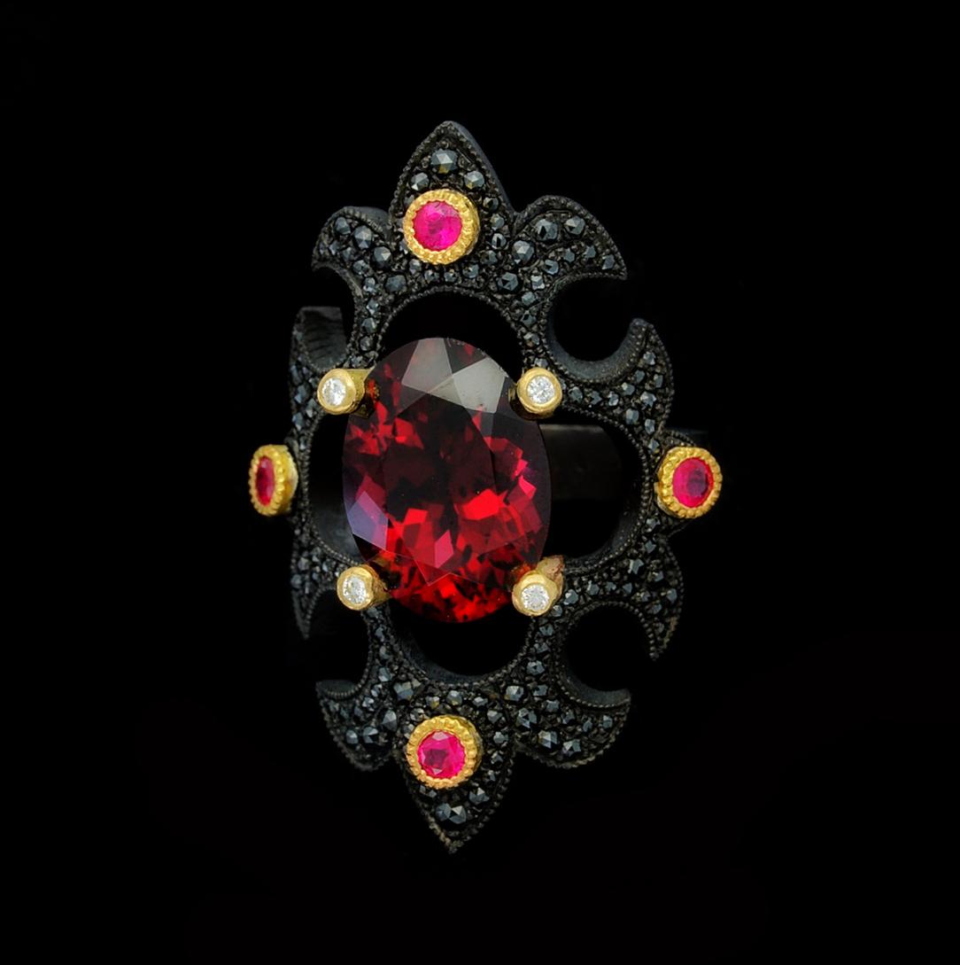 The Eleusinian Princess Ring is a dark splendour with a striking central Rhodolite Garnet that demands attention.

The open back setting allows for the culet of the incredible Rhodolite Garnet to rest upon the top of the wearers finger, touching the