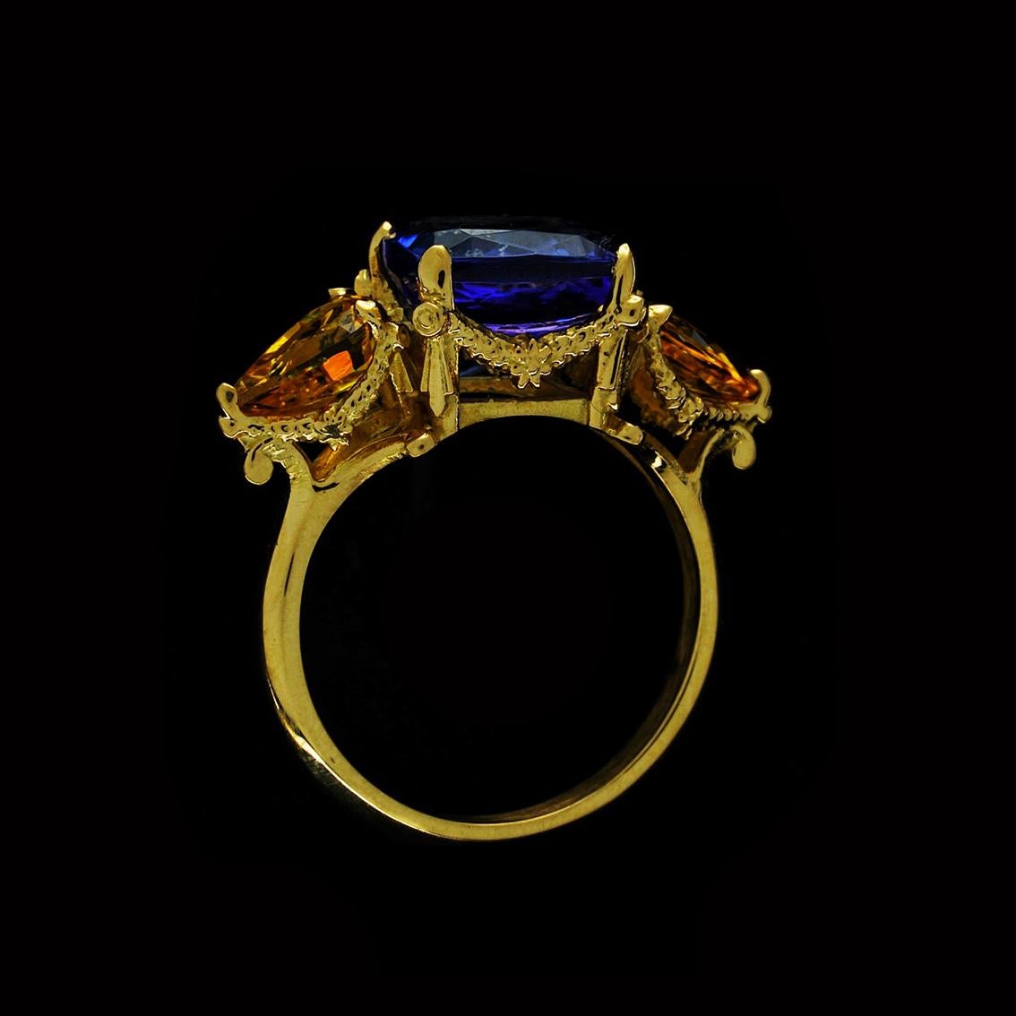The Tanzanite and Yellow sapphire ring is a breathtaking, one of a kind piece and fits a size 7 3/4 (Australian & British size P 1/2).

Handcrafted in 18kt yellow gold, this divine ring features a central faceted 4.1 carat tanzanite, an
