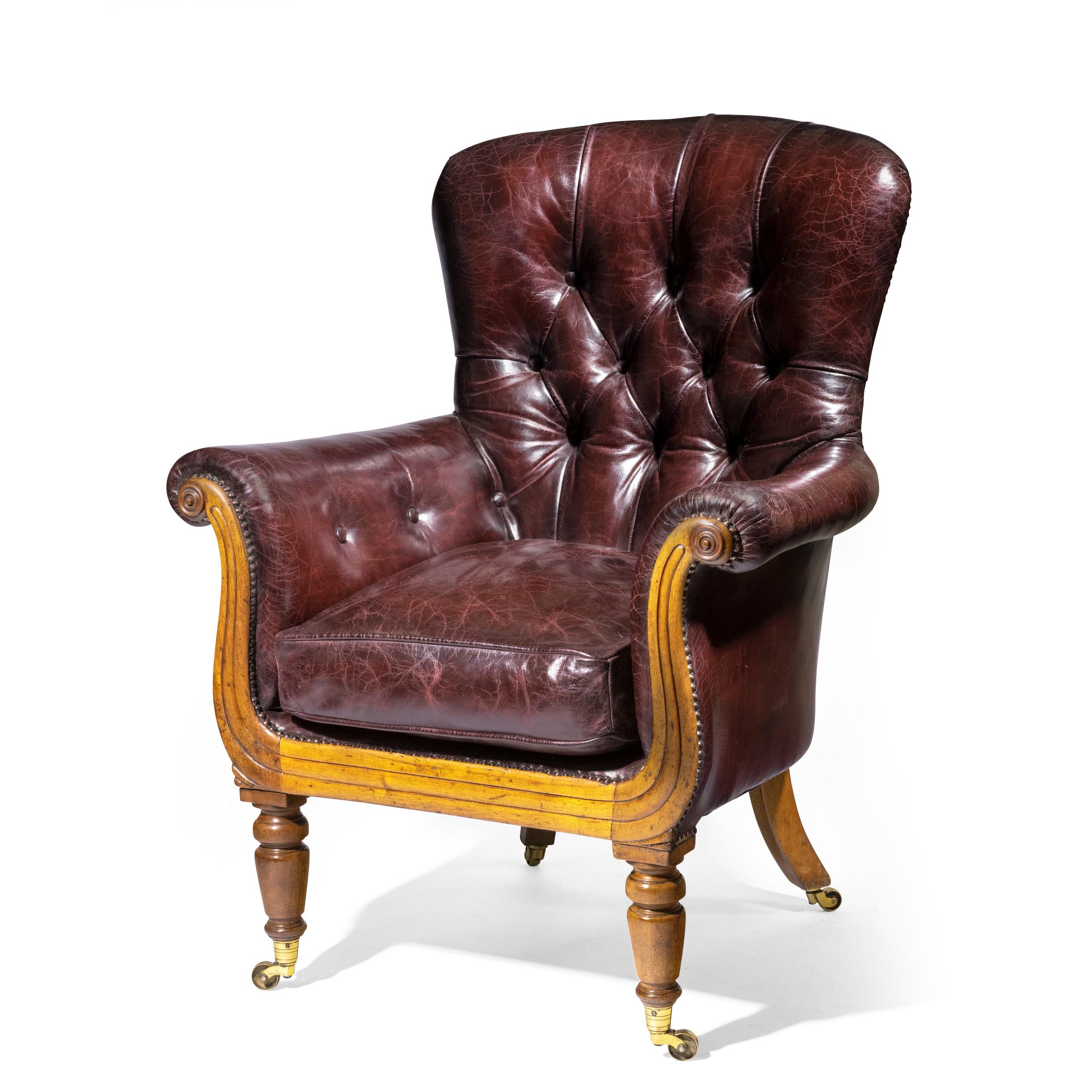 A William IV shaped mahogany library chair of generous proportions. Reupholstered in our own workshops in distressed burgundy leather. Raised on turned legs and brass casters.