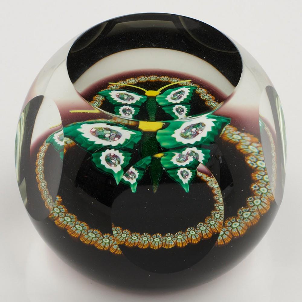 Heading : A William Manson Caithness Complex Cane Butterfly Limited Edition Paperweight 1979
Date : 1979
Origin : Scotland
Features : Green and aventurine bodoed butterfly with complex cane wings and outer concentric ring of millefiori canes
Marks :