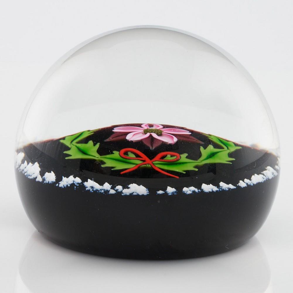 Heading : A Caithness William Manson Lampwork Noel Limited Edition Paperweight 1987
Date : 1987
Origin : Scotland
Features : Lampwork flower and wreath with outer ring of snow on a black ground
Marks : Caithness Noel Scotland 11/250
Type : Lead
Size