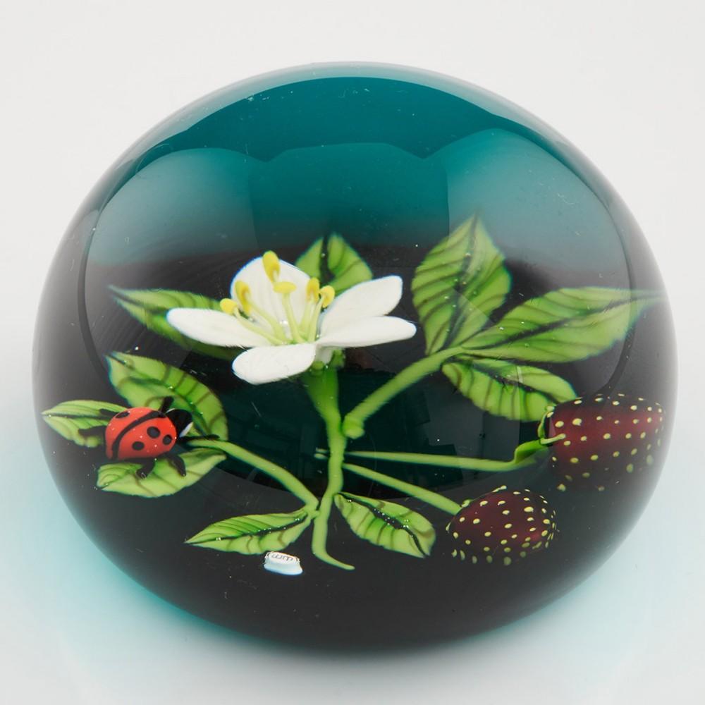 Heading : A William Manson strawberry paperweight
Date : 1992
Origin : Scotland
Features : Turquoise ground with a flowering and fruiting strawberry plant and ladybird
Marks : Signed William Manson 1992 and contains a WM cane
Type : Lead
Size :