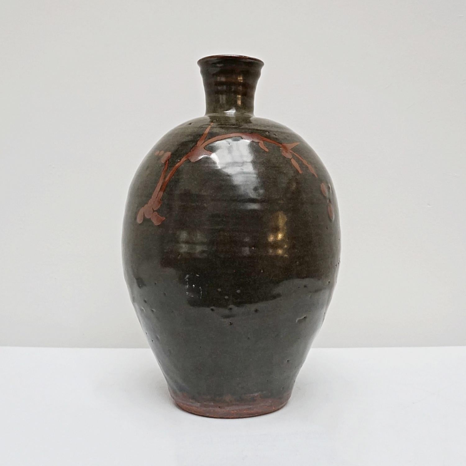 A large black tenmoku glazed stoneware vase with flower motif by William Marshall (1923-2007). 

Dimensions: H 37cm

Origin: English

Date: Circa 1960.

Williams Marshall (1823-2007) was an English studio potter. His life with clay began in 1934