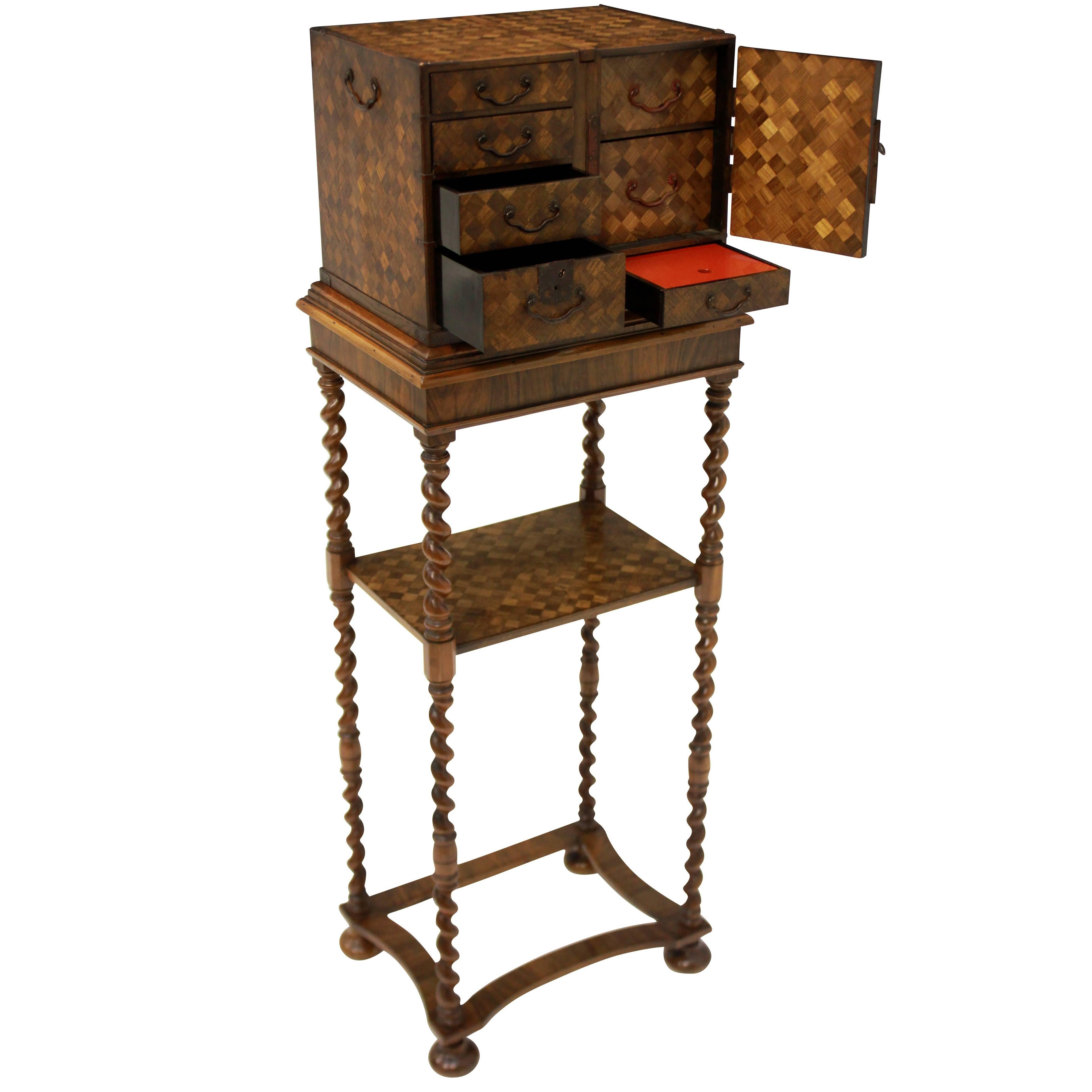 An English William & Mary chest on Stand in walnut and oak, with a Japanned interior of red and black lacquer.