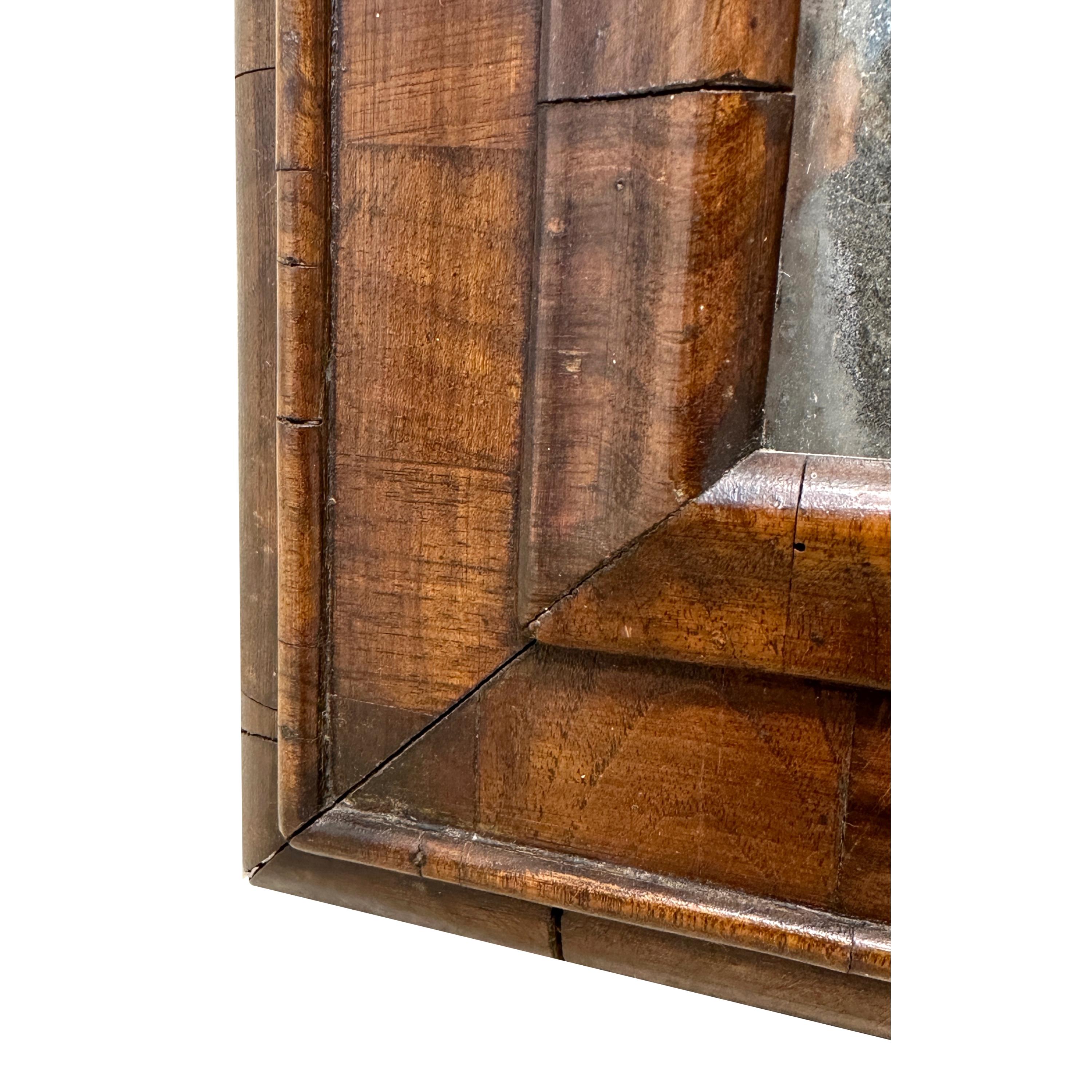 An Extremely Charming Late 17th Century William & Mary Period Walnut Cushion Framed Wall Mirror, Of Exceptional Untouched Colour And Patina, Retaining Original Mirror Plate.


This is one of the most charming little mirrors that we have owned for