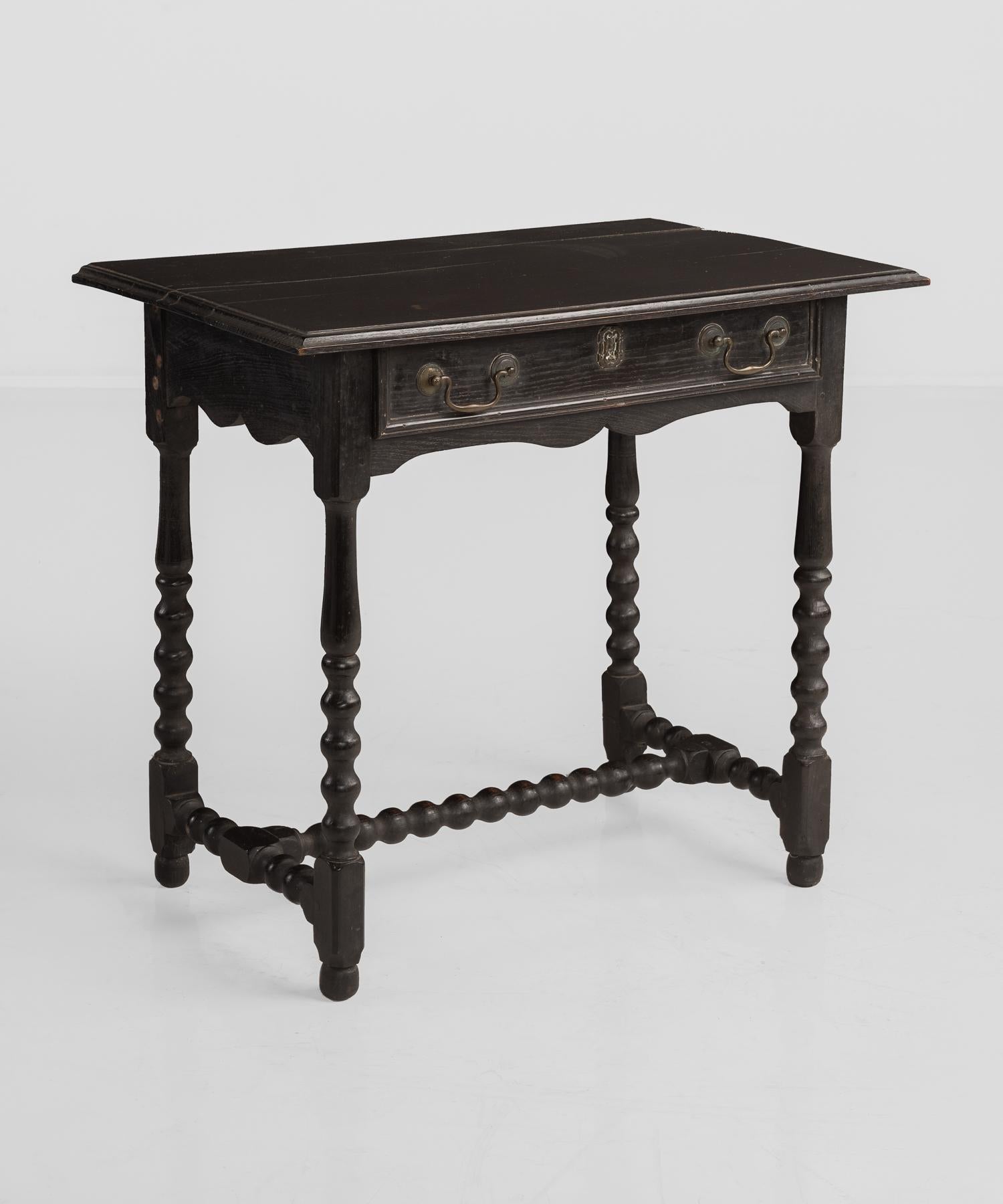 William & Mary ebonized oak side table, circa 1880.

Simple form on bobbin base with original brass hardware.