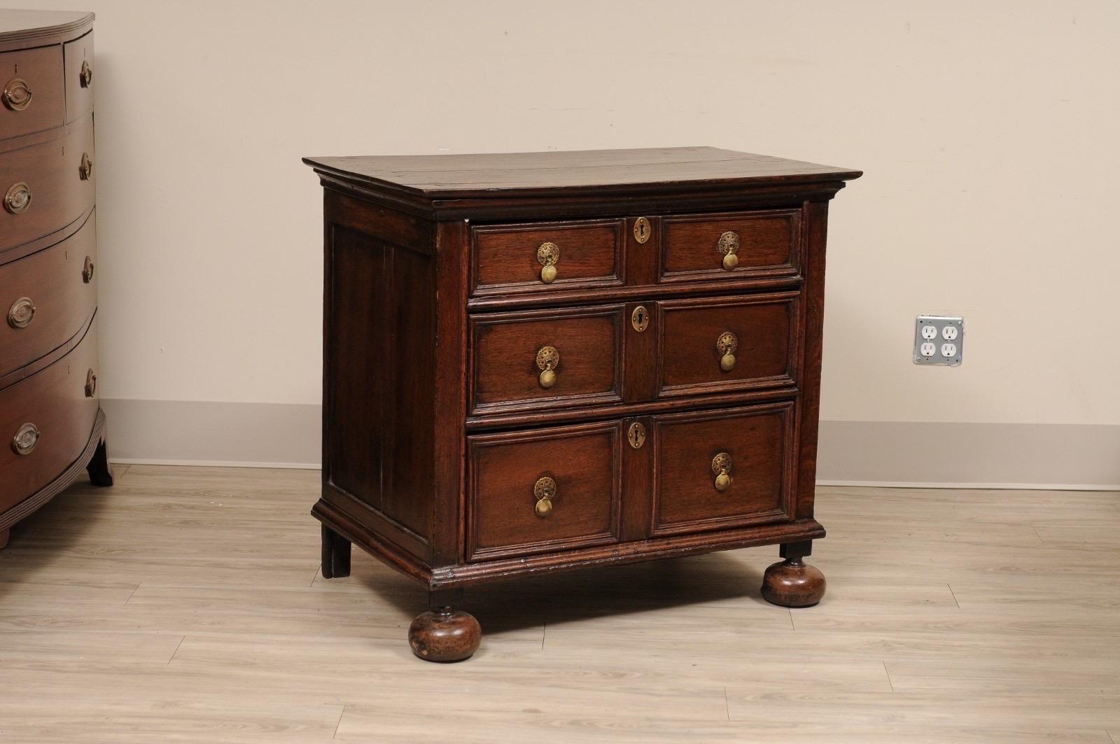 Beautiful English Late 17th-century William & Mary Jacobean Small Chest made of solid walnut.  Tear-Drop Brass Hardware with Bun Feet. Locks are present, but no key.