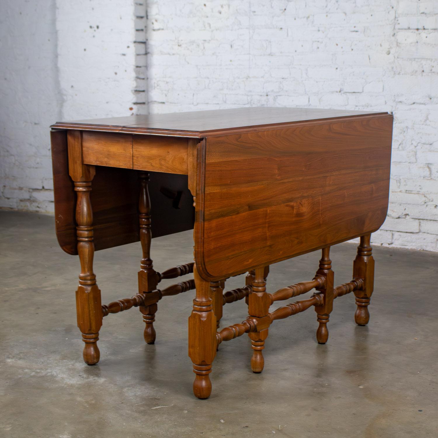 Handsome William & Mary style walnut drop leaf expanding gateleg dining table by Abernathy Furniture with 2 removeable leaves. Beautiful condition, keeping in mind that this is vintage and not new so will have signs of use and wear even if it has