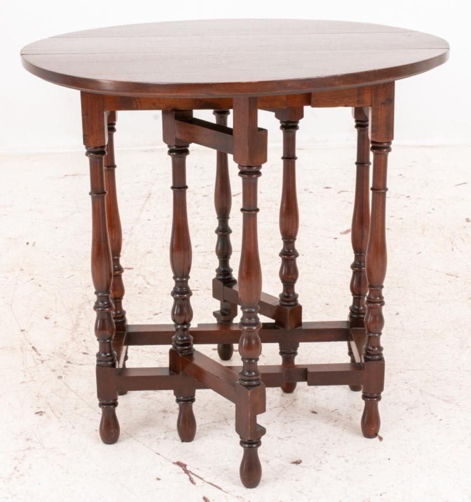 William & Mary style mahogany drop leaf coffee table having two D-shaped drop leaves raised on turned gate leg base. Open: 26.5
