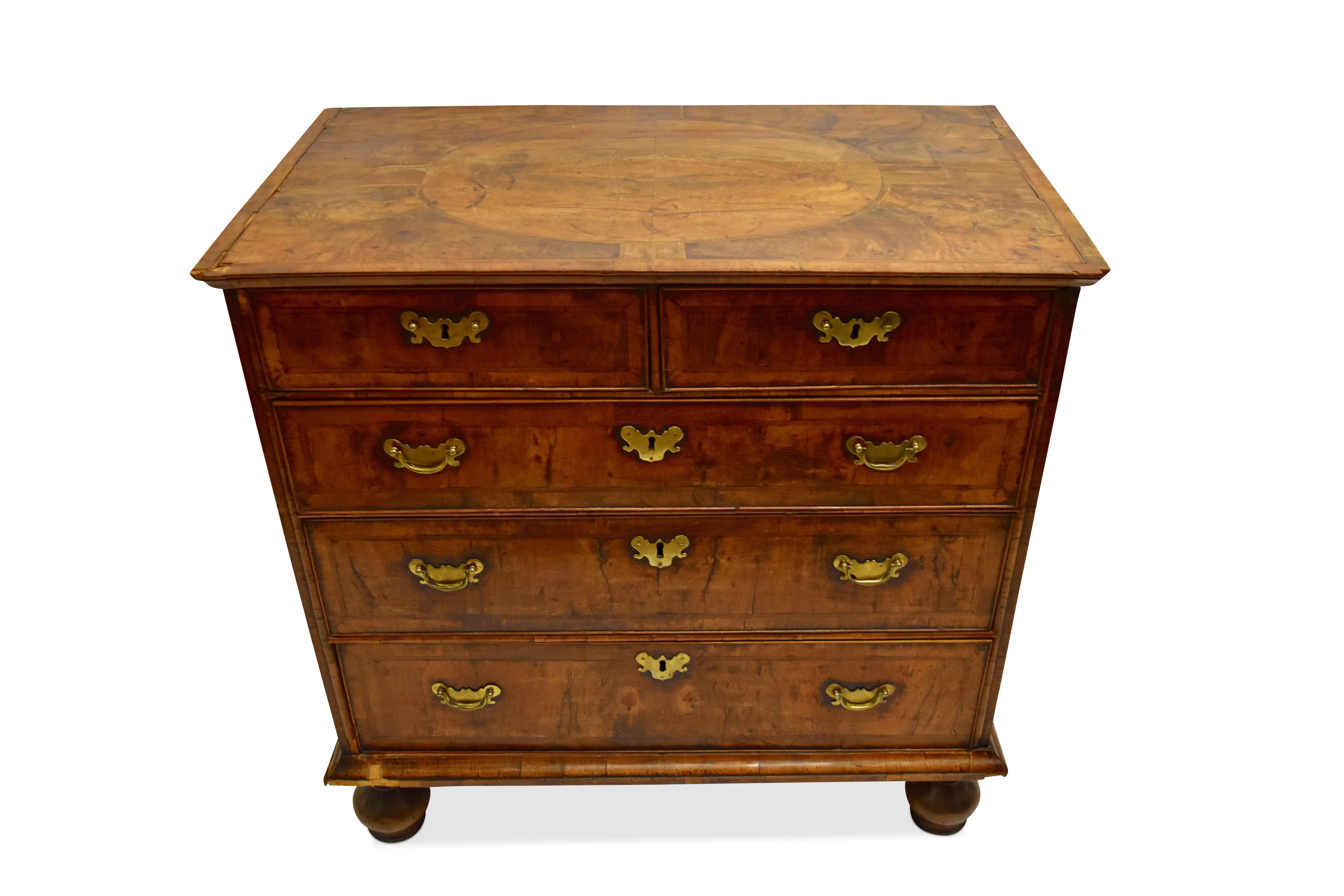 The inlaid top over 2 short drawers and 3 long drawers each with pen line inlay and the whole on bun feet.

Restoration needed...