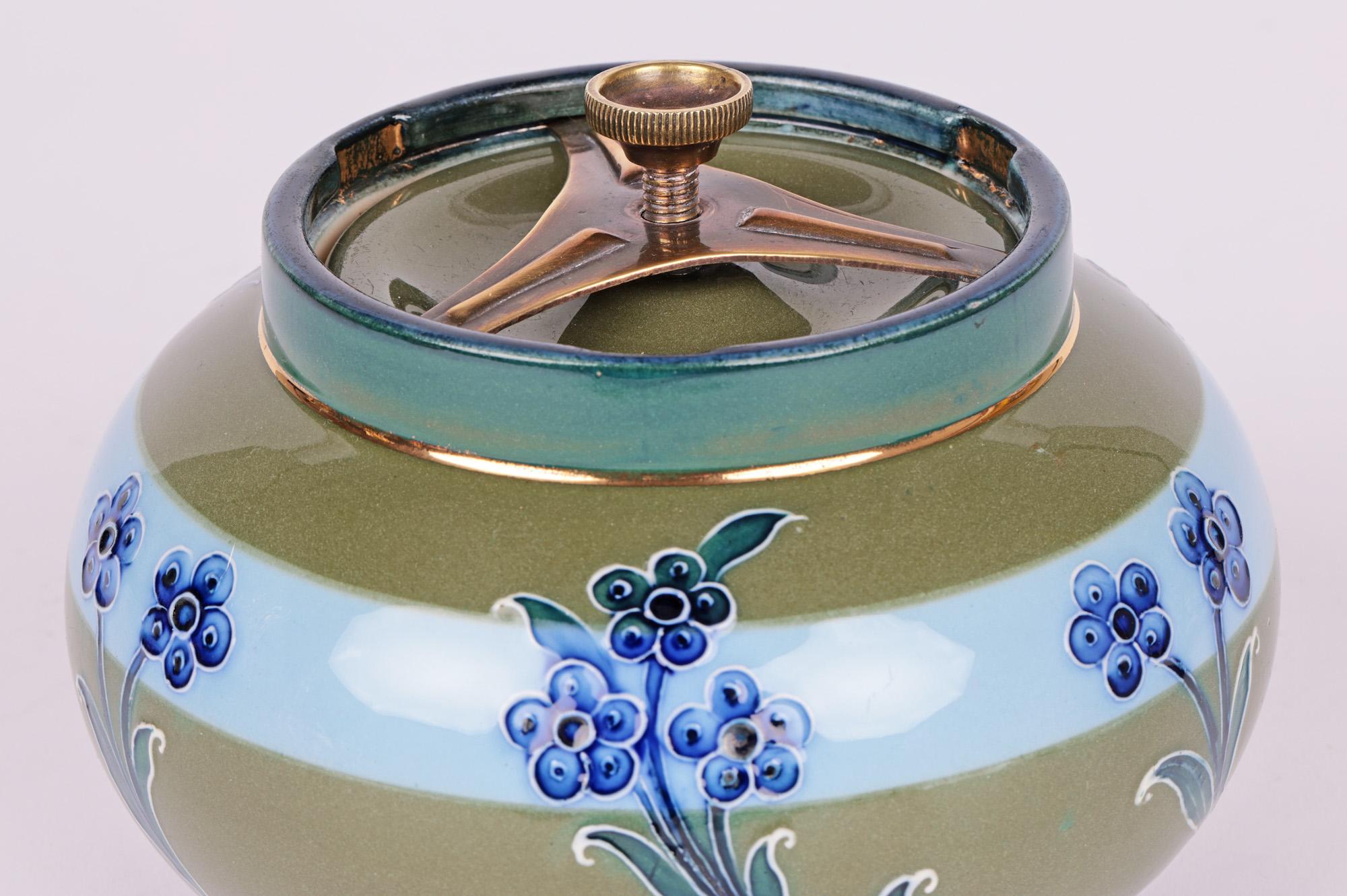 Art Nouveau James MacIntyre & Co lidded tobacco jar decorated with tubelined daisies designed by William Moorcroft (English, 1872-1945) and dating from around 1900. William Moorcroft started out as a designer before becoming director of the art