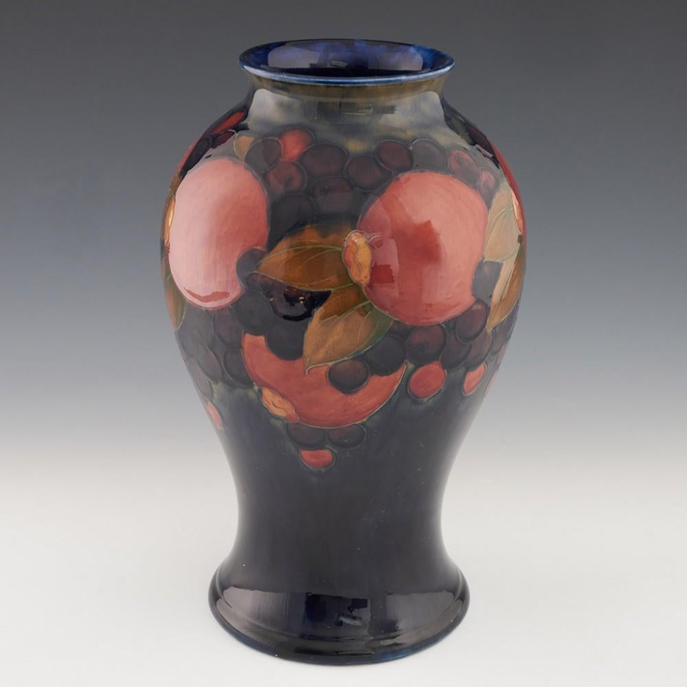 Heading : William Moorcroft pomegranate pattern vase
Date : c1930
Origin : Burslem, England
Bowl Features : Baluster form with pomegranate decoration
Marks : William Moorcroft signature in blue along with MADE IN ENGLAND MOORCROFT stamped to