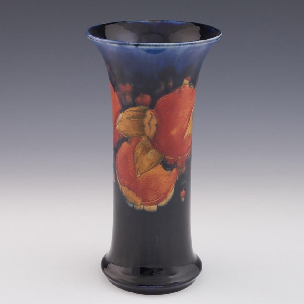 William Moorcroft Pomegranate Pattern Trumpet Vase, circa 1930

Additional Information:
Date: c.1930
Origin: Burslem, England
Bowl Features: Blue ground, with polychrome pomegranate decoration
Marks: Moorcorft made in england stamped along