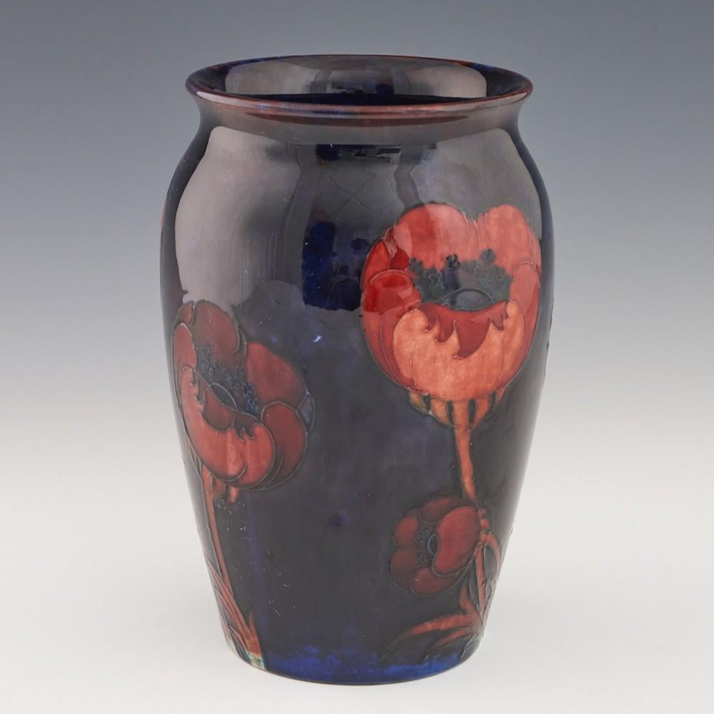 Heading : A William Moorcroft poppy vase
Date : c1925
Origin : Burslem, England
Features : Indigi-blue ground with  five large poppies.
Marks : WM signature and stamped MOORCORFT
Type : Pottery
Size : 21.1cm height, 12.3cm diameter
Condition : Very