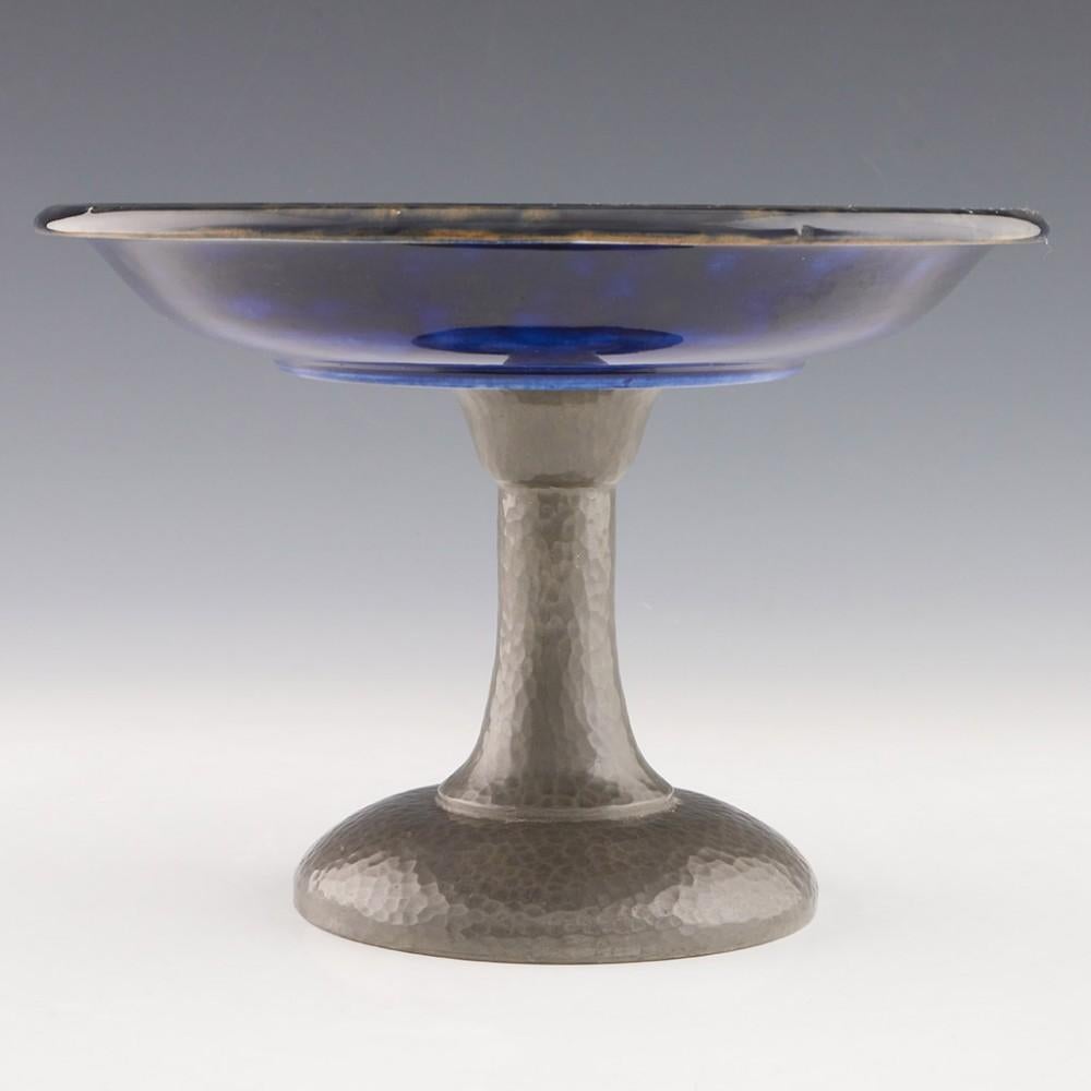 Heading :  A William Moorcroft Pomegranate Pattern Pewter Mounted Tazza
Date : c1915
Period : George V
Marks :The pottery tazza is signed with impressed marks and blue monogram. The pase of the pewter stand is marked Tudric Moorcroft 01313
Origin :