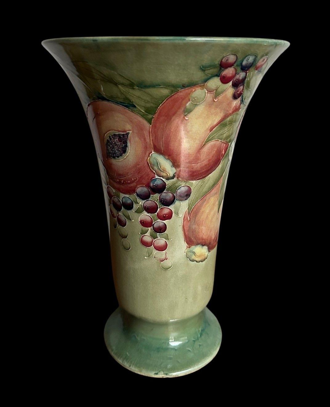5474
A Large and Early William Moorcroft Footed Vase decorated in the Pomegranate design on a Scarce Caledon Green Ground.
Typical Crazing and a minute nick to the footrim
Circa 1912
30cm high, 20.5cm wide