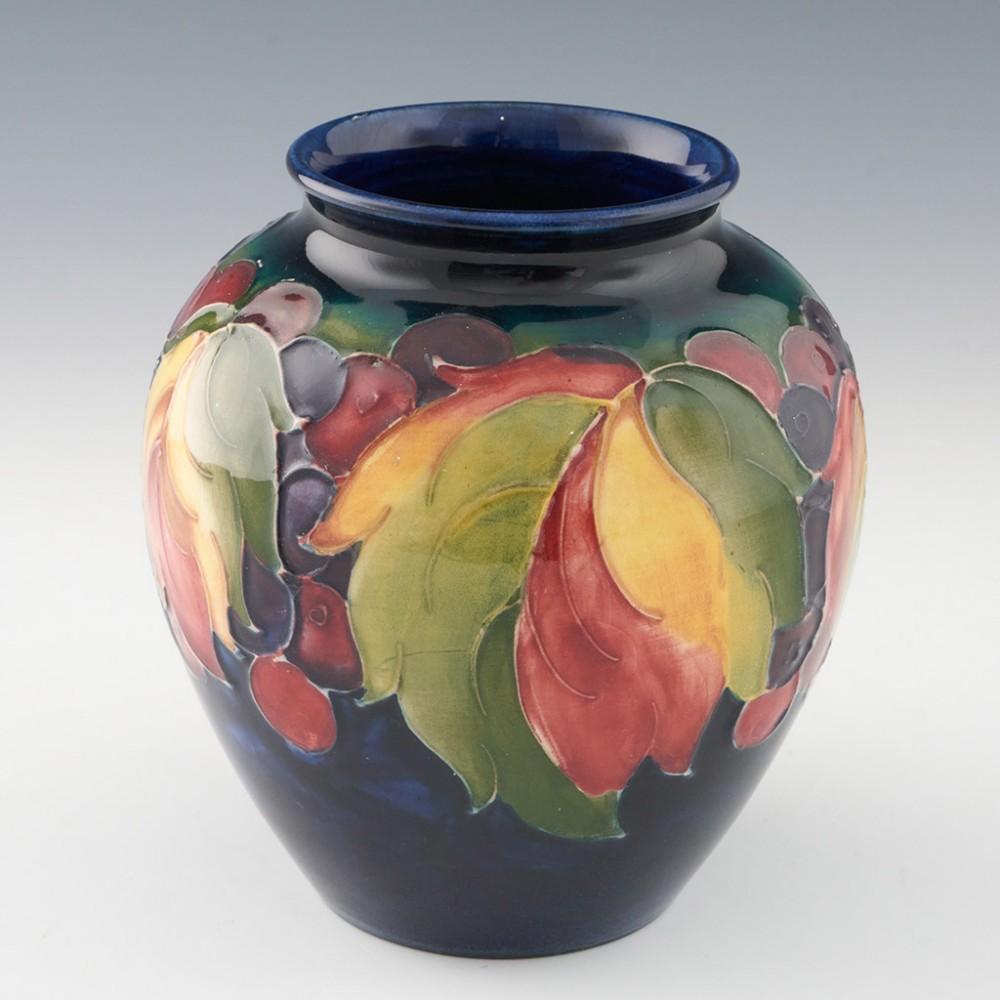 Heading : William Moorcroft pottery Wisteria Plum vase
Date : c1940
Origin : Burslem, England
Bowl Features : Baluster form with wisteria plum decoration.
Marks : Stamped MADE IN ENGLAND  and POTTER TO HM THE QUEEN
Type : Pottery
Size : 13.5cm