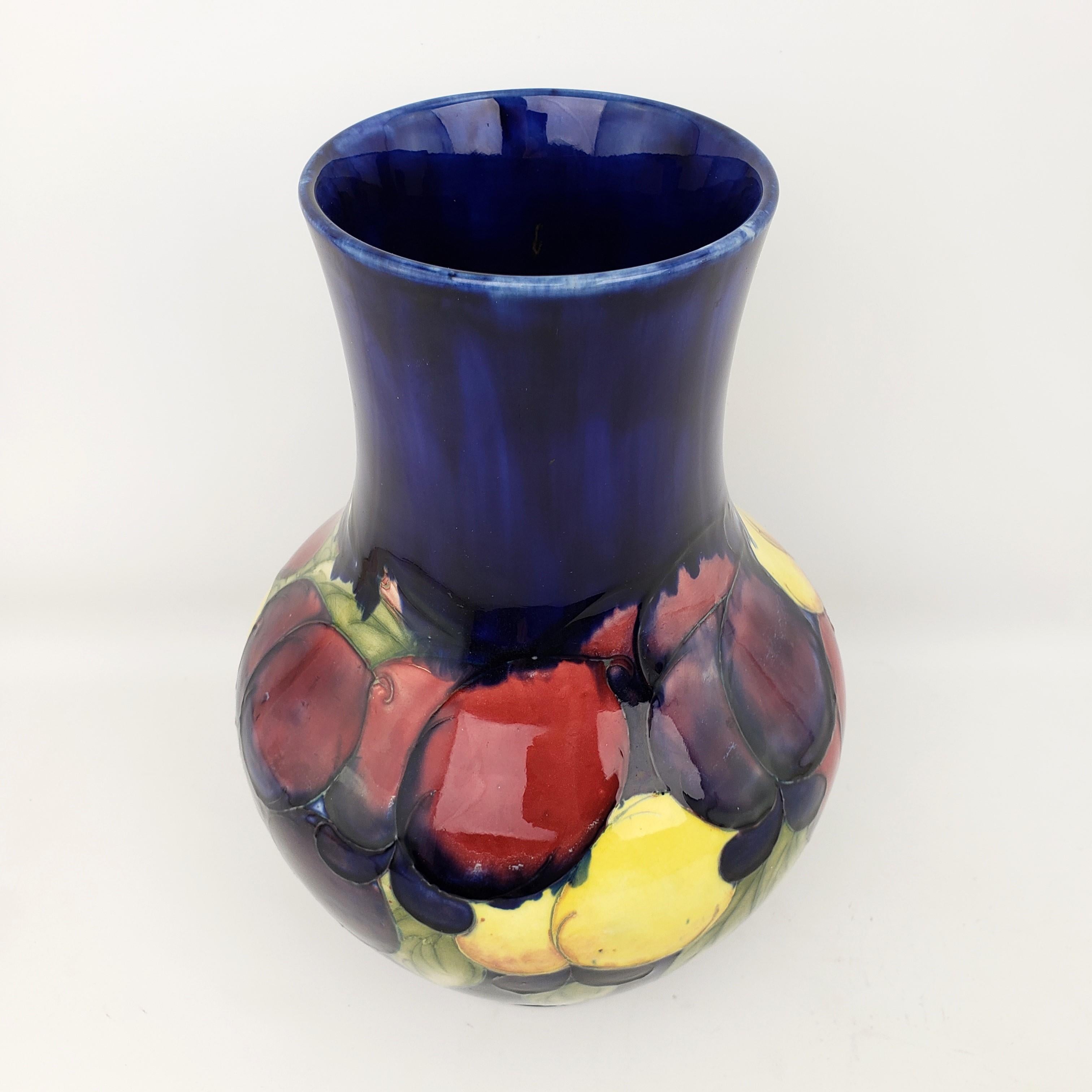 A large size and lovely vase beautifully decorated in 'Wisteria' pattern; designed and produced by William Moorcroft. It features fine tube lining and rich colours on a deep cobalt blue ground.